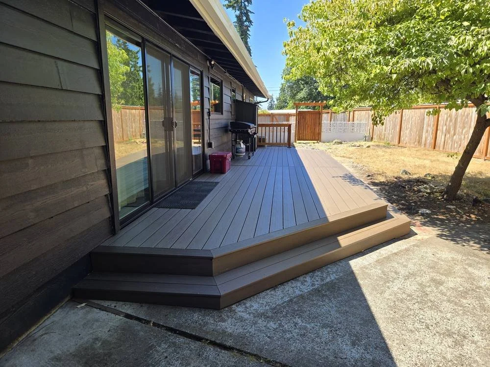 Edmonds TimberTech Dark Cocoa composite deck with wraparound steps and cedar railing