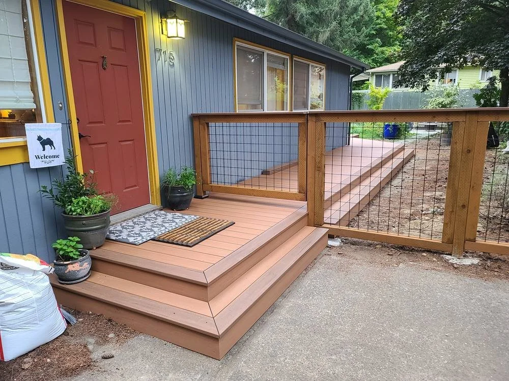 PVC deck walkway wrapping around the house to the front porch steps with wood and wire railing