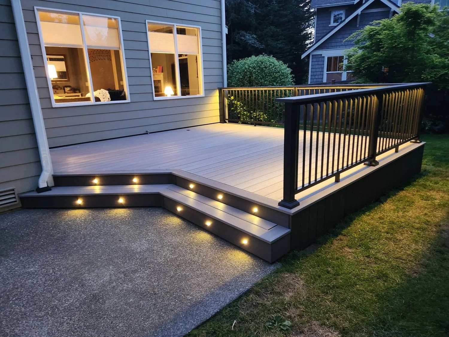Composite deck with stair and drink rail lighting at dusk in Lynnwood, WA