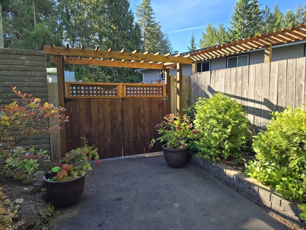 Stained cedar gate and arbor with lattice top panels in Edmonds