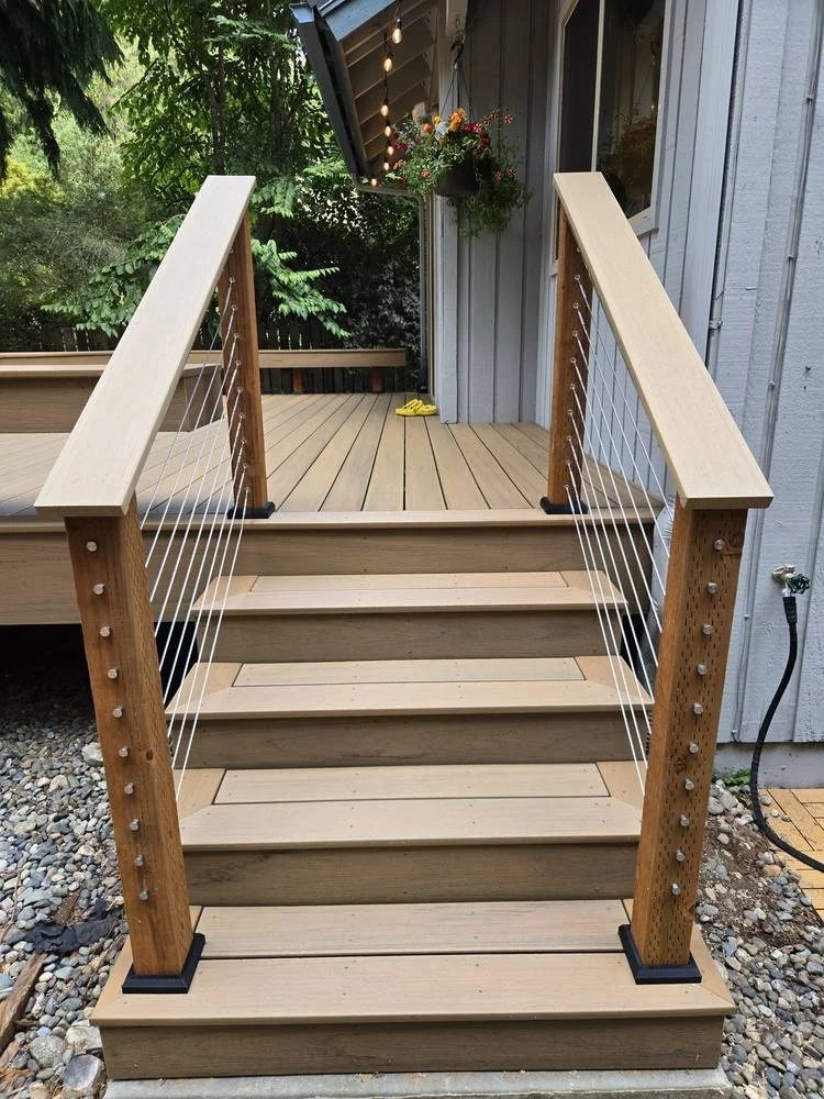 Composite deck stairs with wood railings and stainless steel cable rail in Edmonds