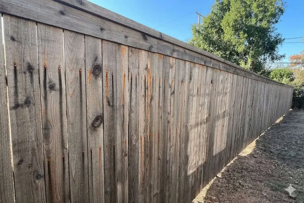 Black stains on an aging cedar fence