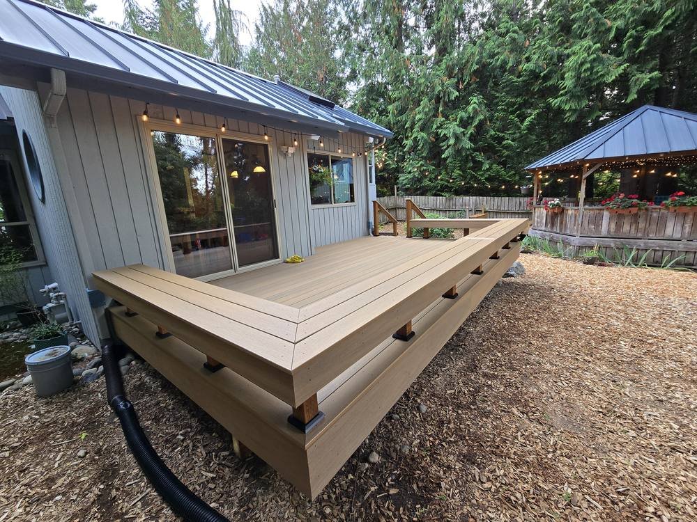 Wraparound bench seat on an Edmonds composite deck replacement with the backyard gazebo beyond