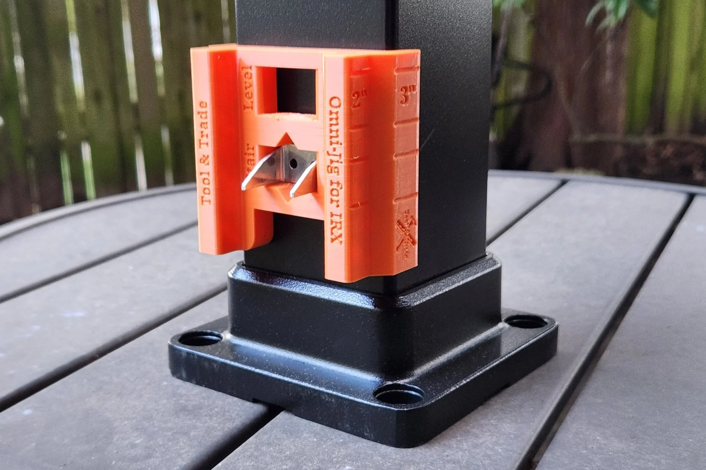 Close-up of an IRX Aluminum Railing post with an orange installation jig and clip