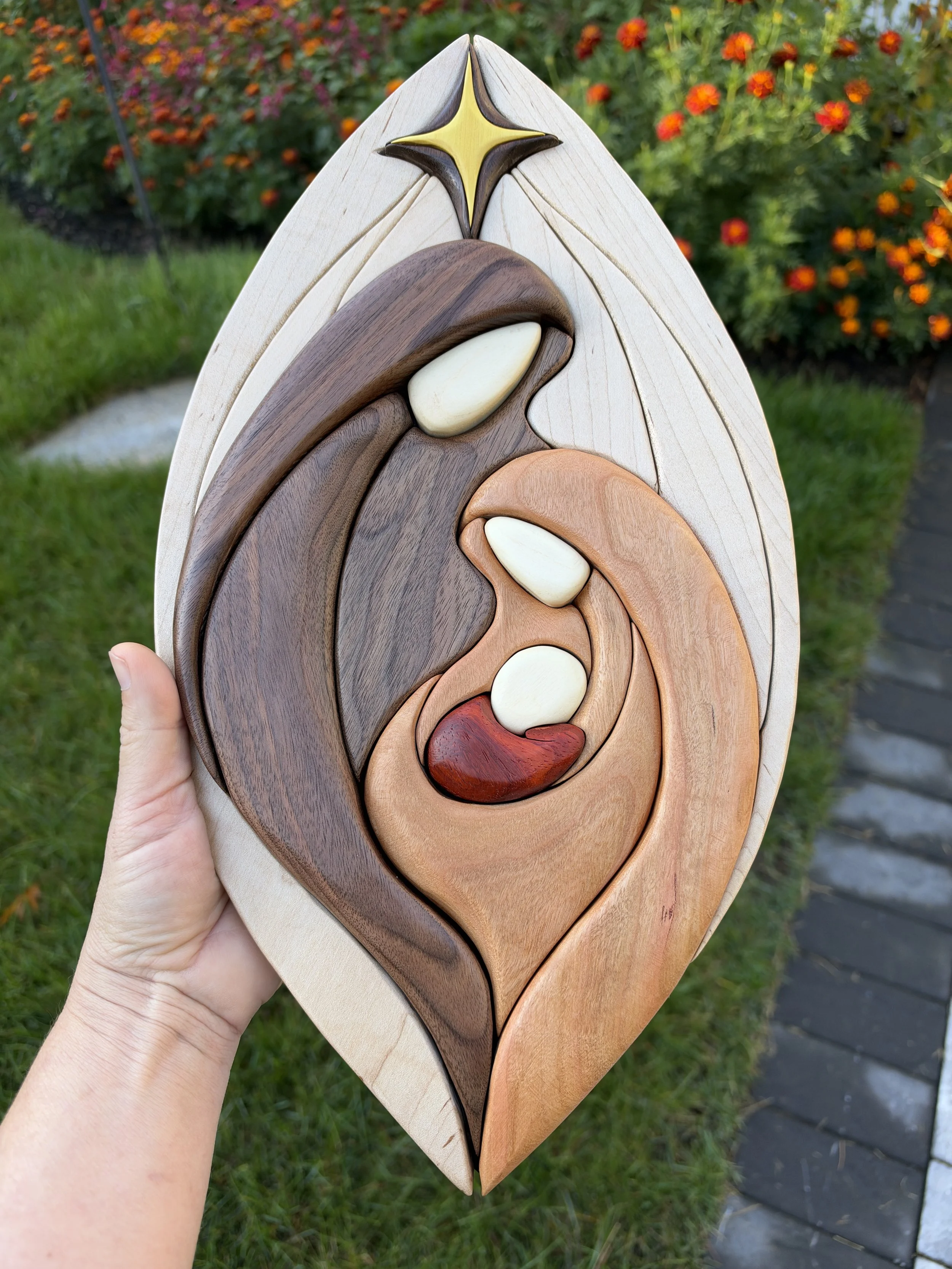 Close front view of the intarsia Holy Family wall art outdoors