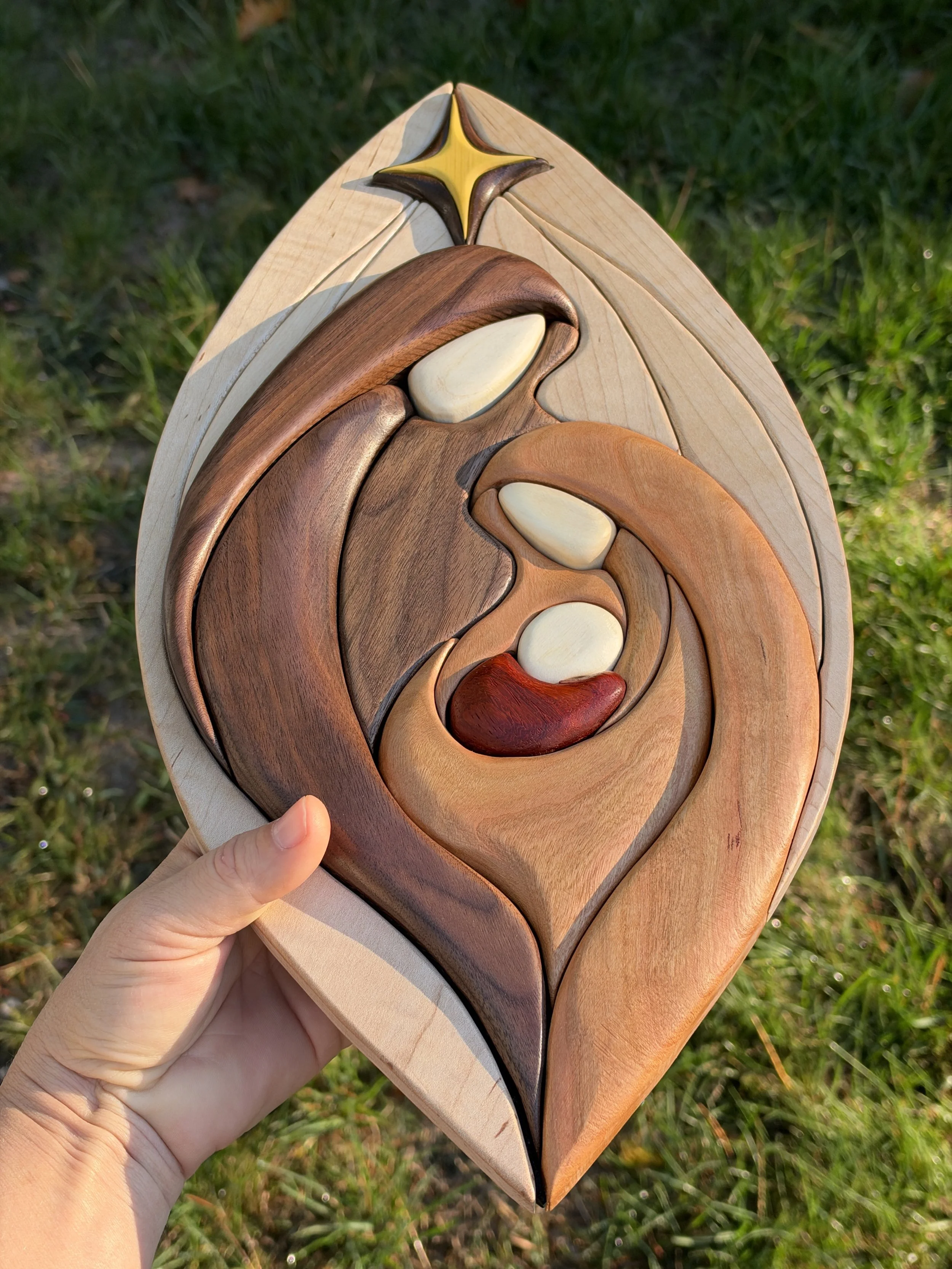 Detail of curved wood pieces forming the Holy Family nativity scene