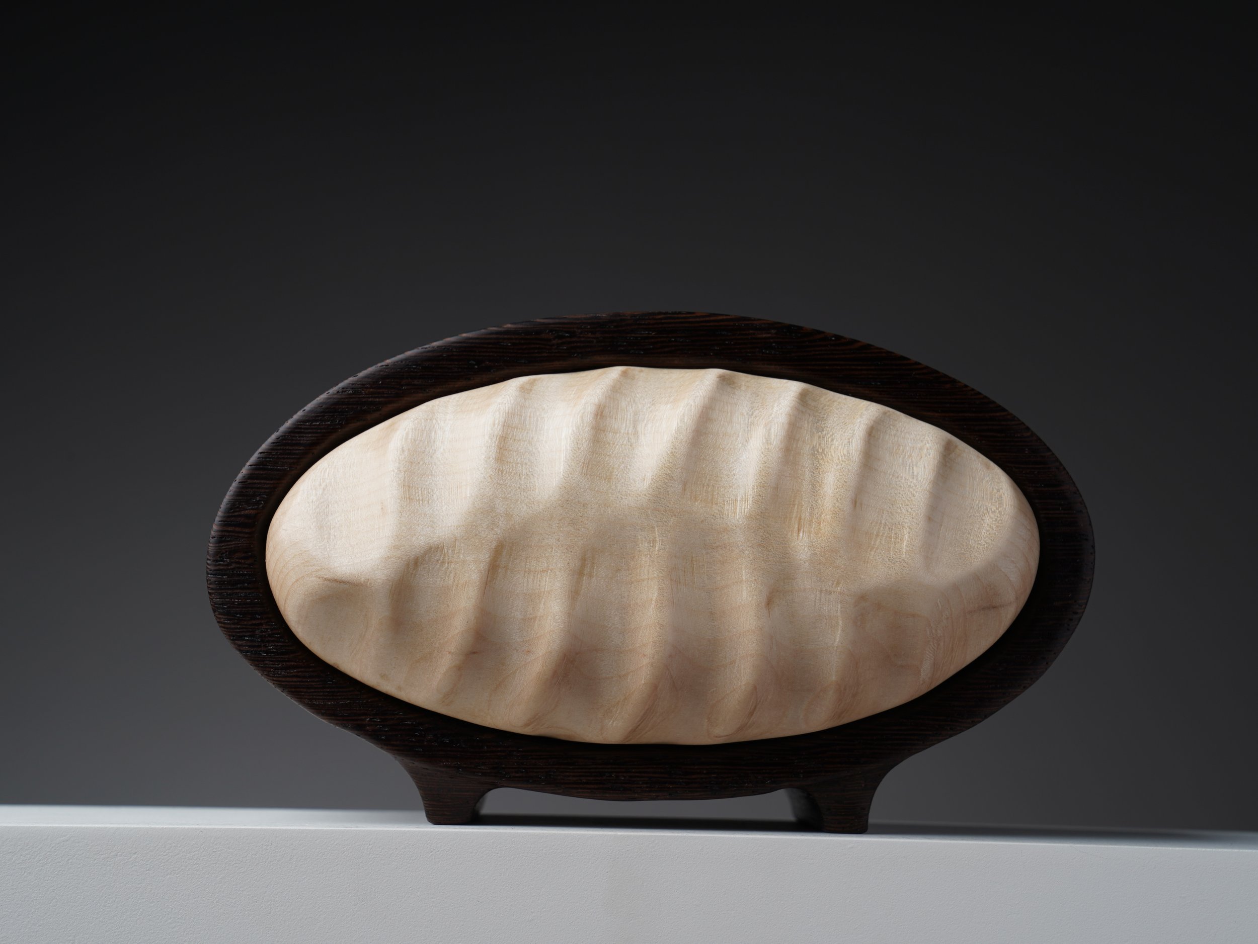 Front view of the wenge bandsaw keepsake box with hand-carved curly maple waves.