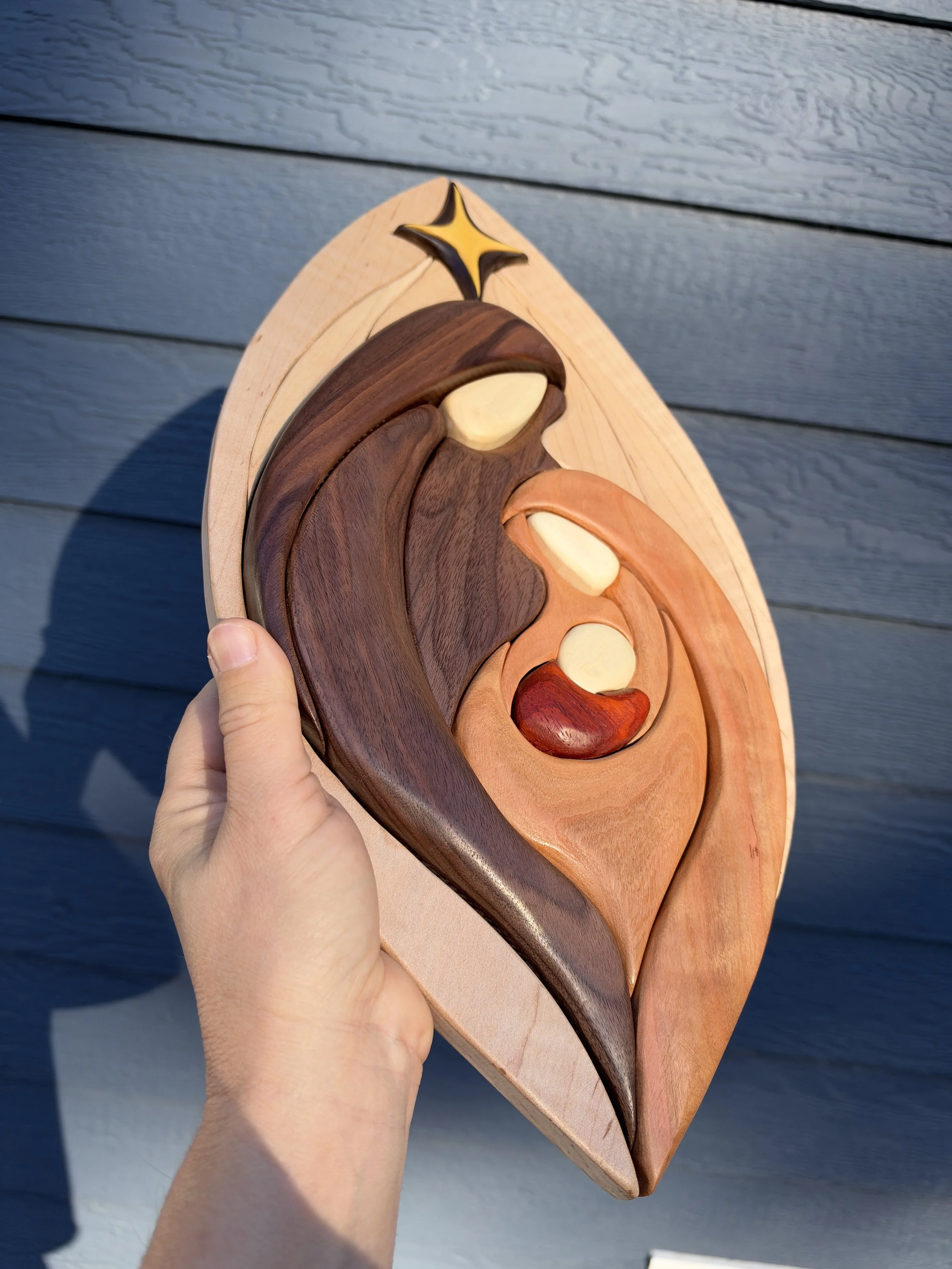 Angled view of the intarsia nativity scene and star
