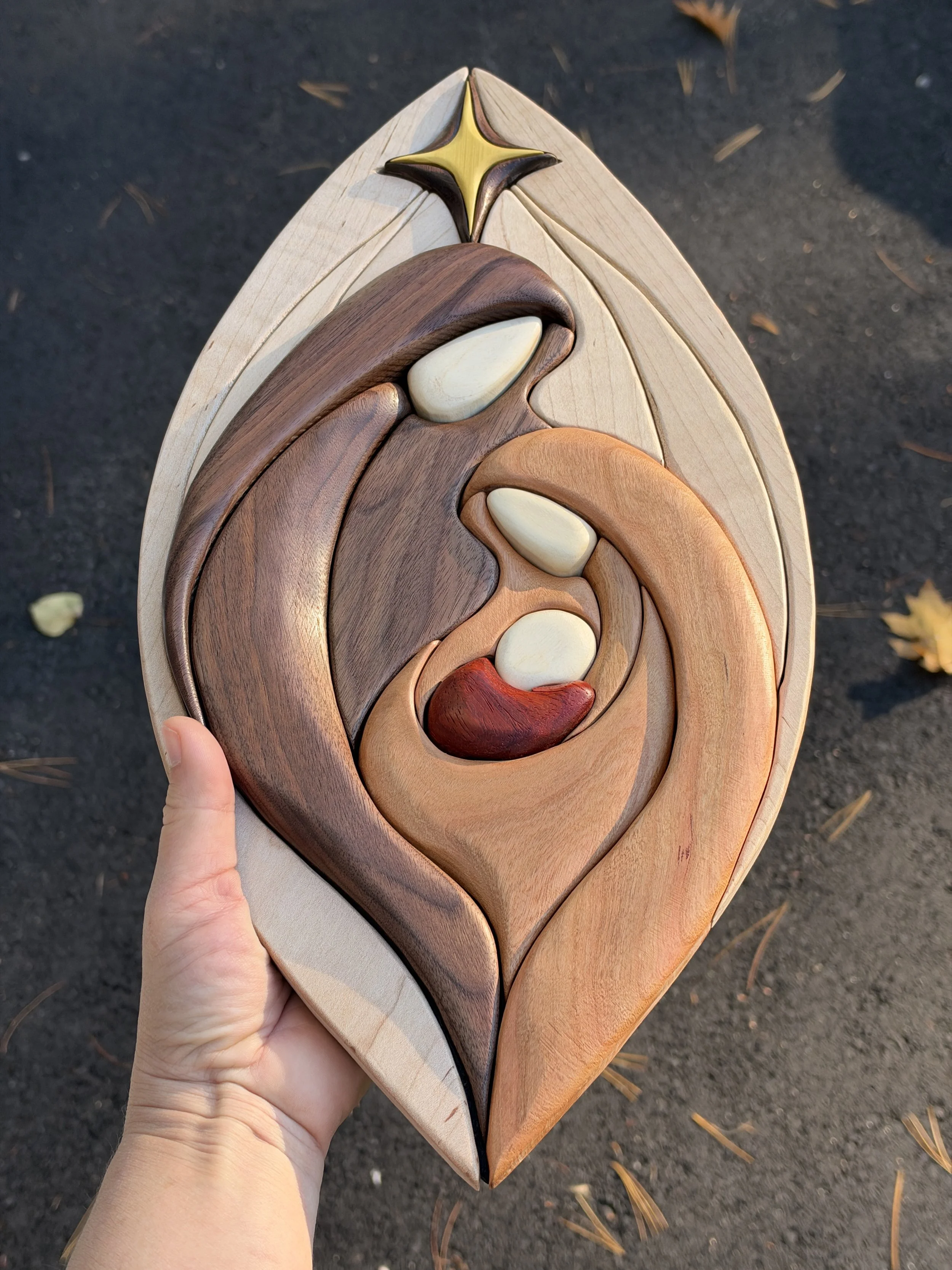 Close view of Mary and baby Jesus in the wooden intarsia nativity