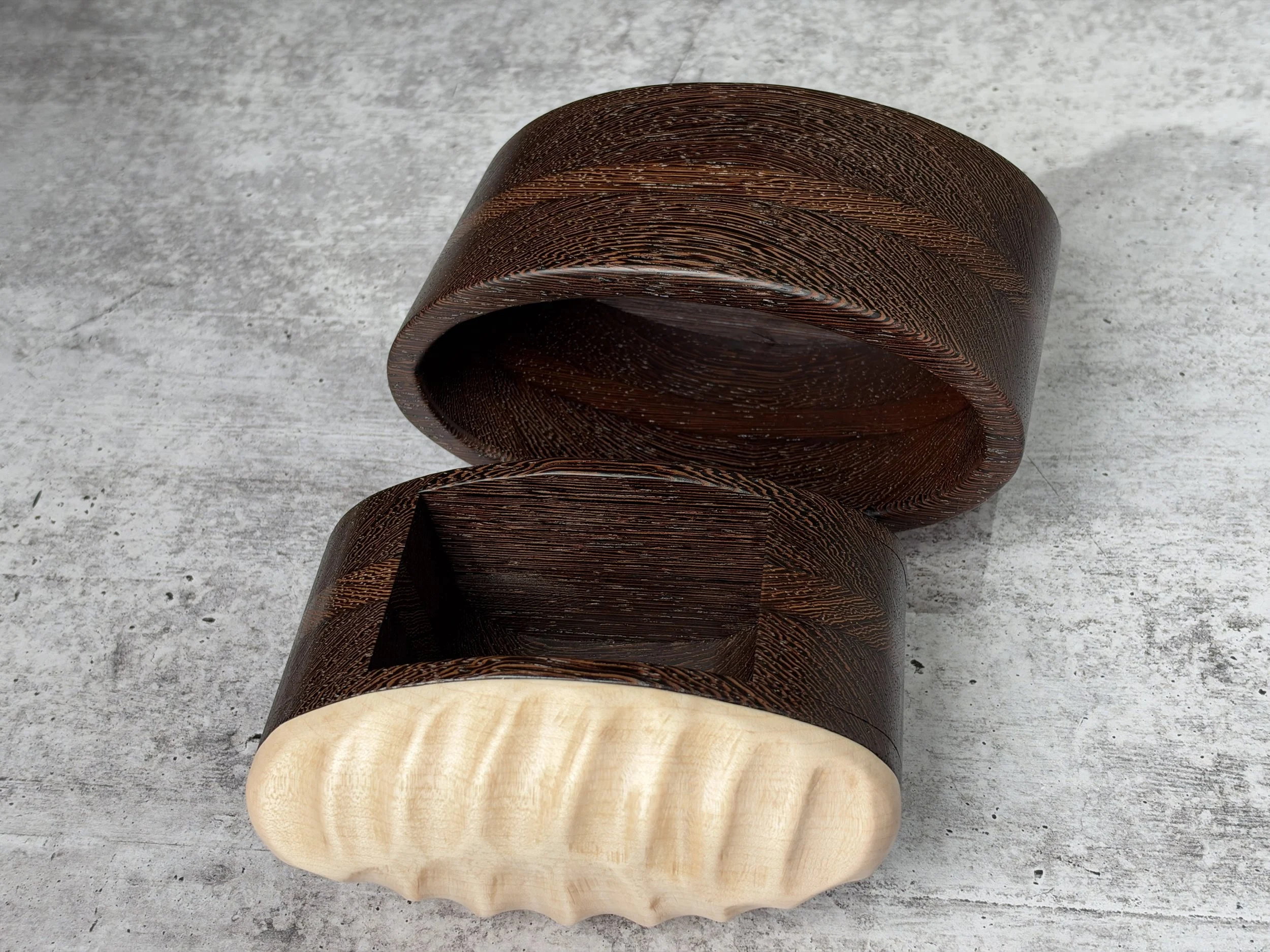 Open keepsake drawer beside the oval wenge bandsaw box.