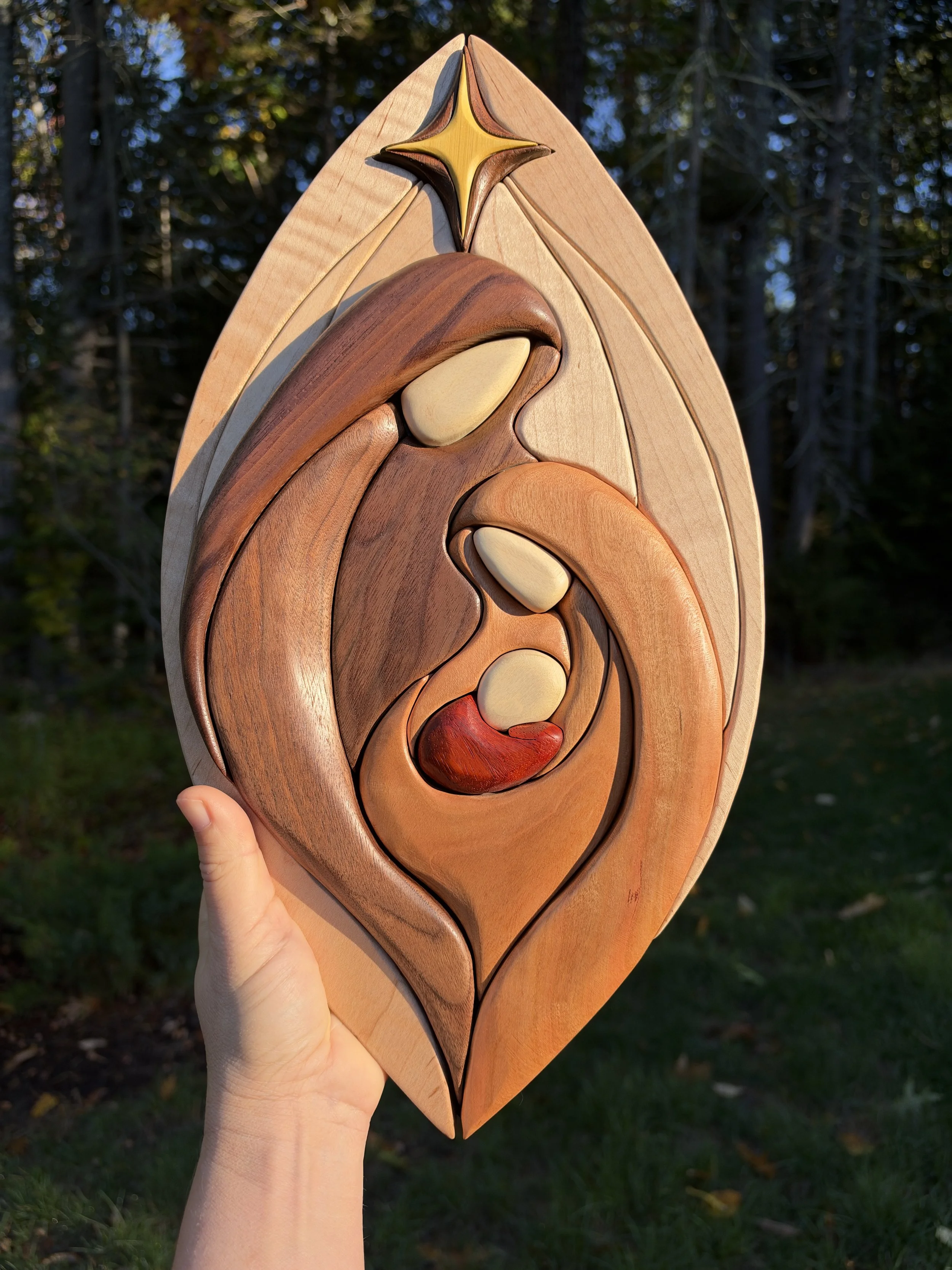 Close view of the wooden nativity scene with contrasting natural wood colors