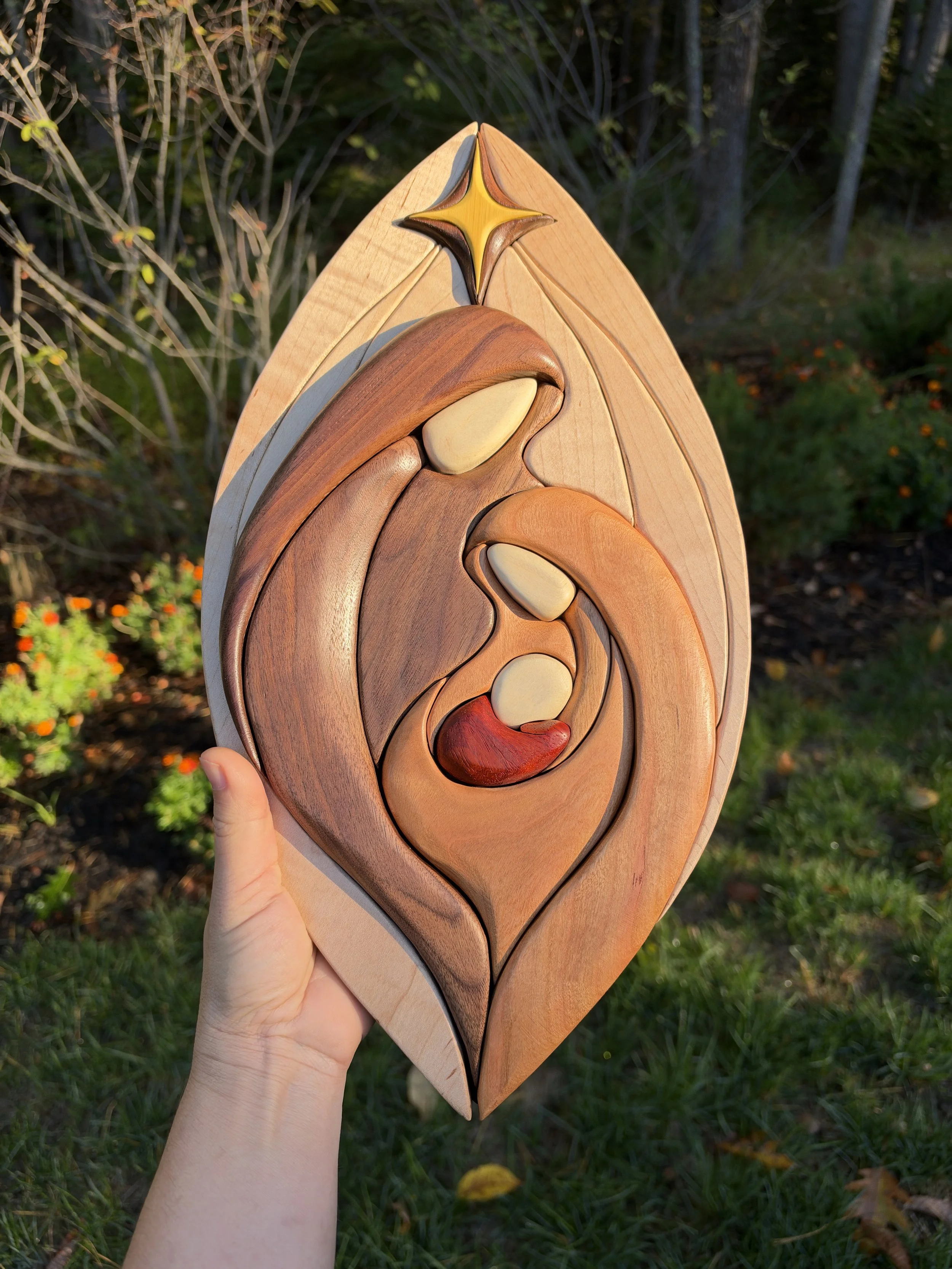 Handheld view of the natural wood nativity wall hanging