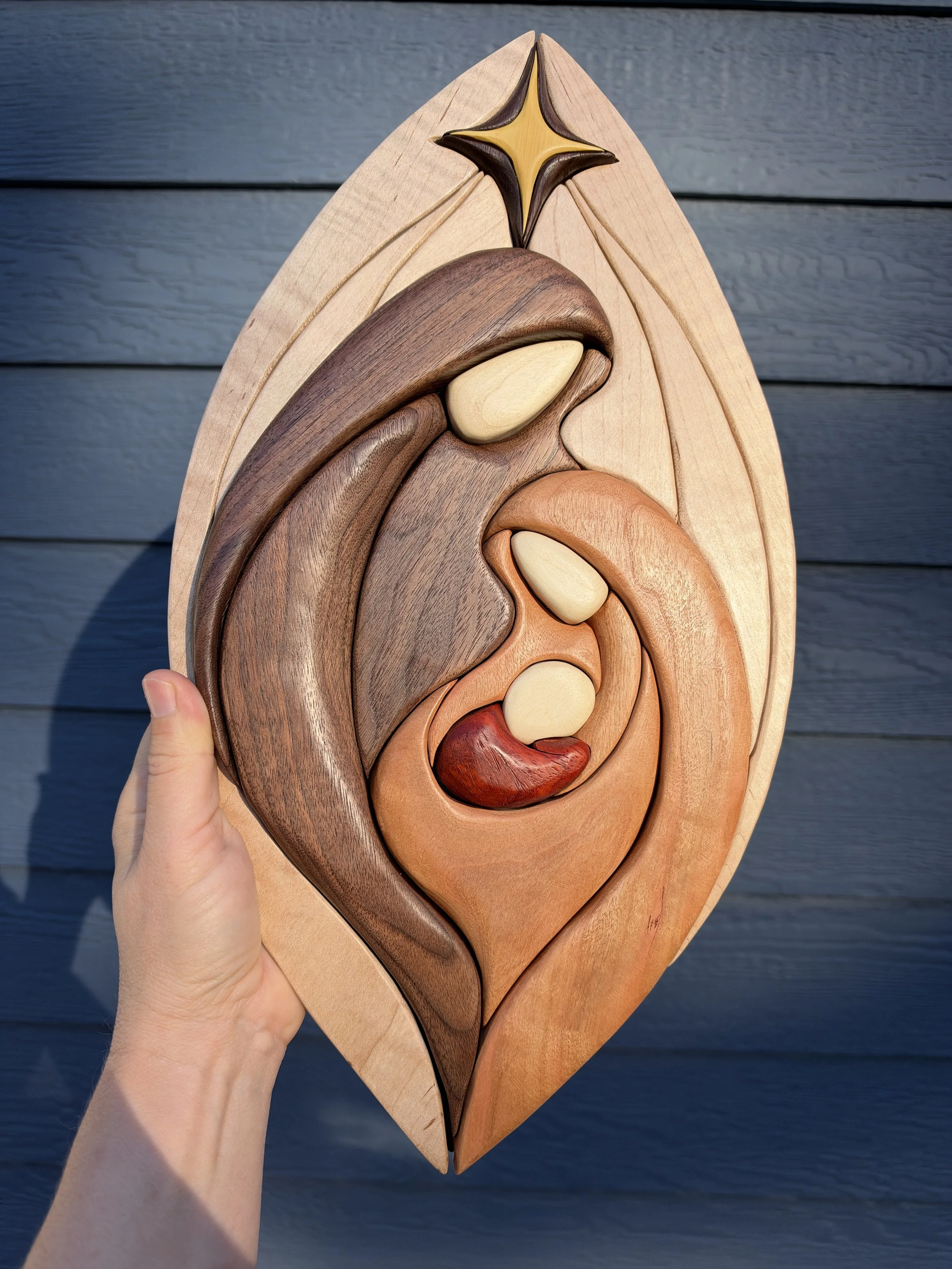 Close-up of contrasting wood grain in the Holy Family wall hanging
