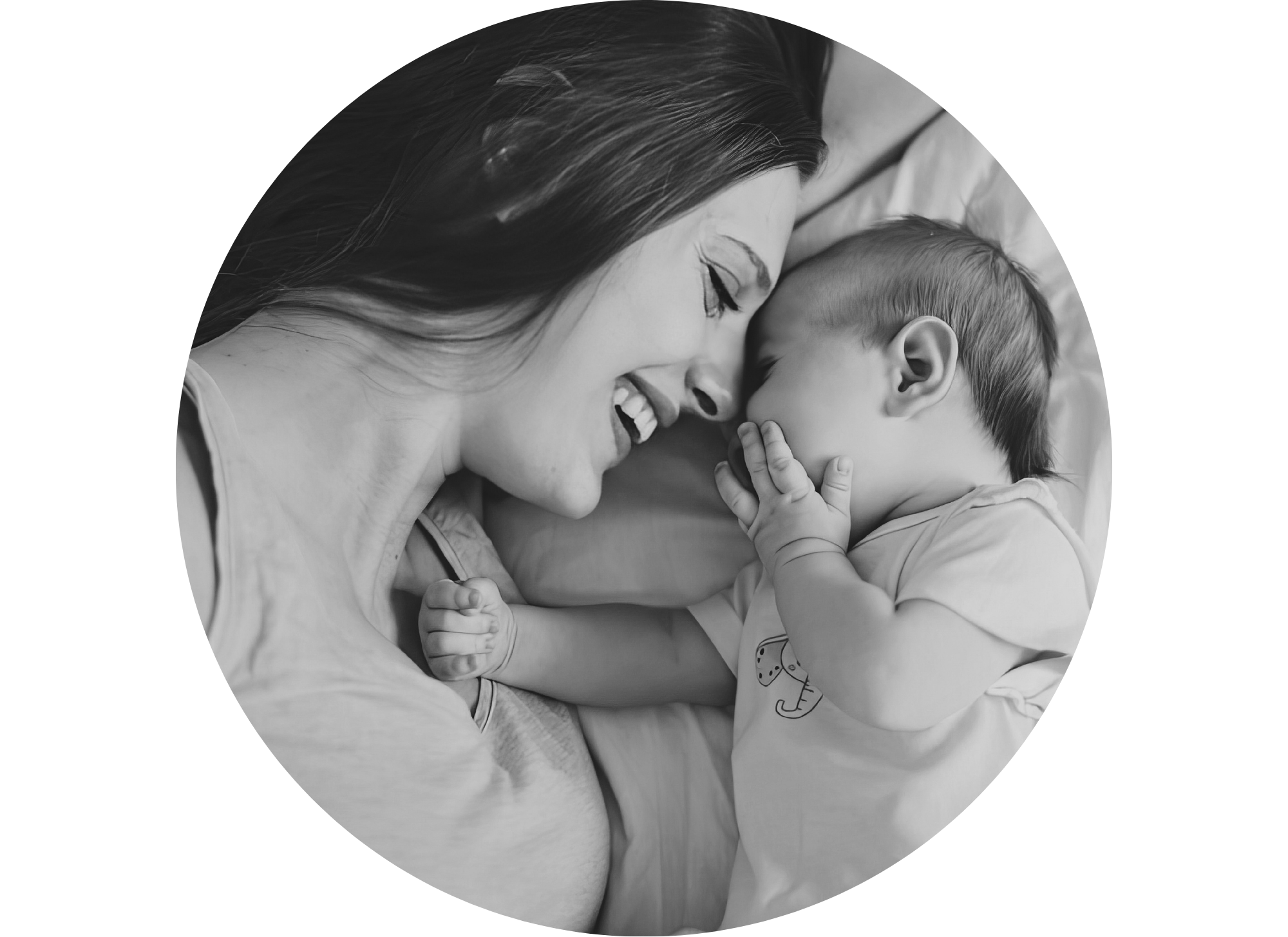 Mother smiling and cuddling with her newborn