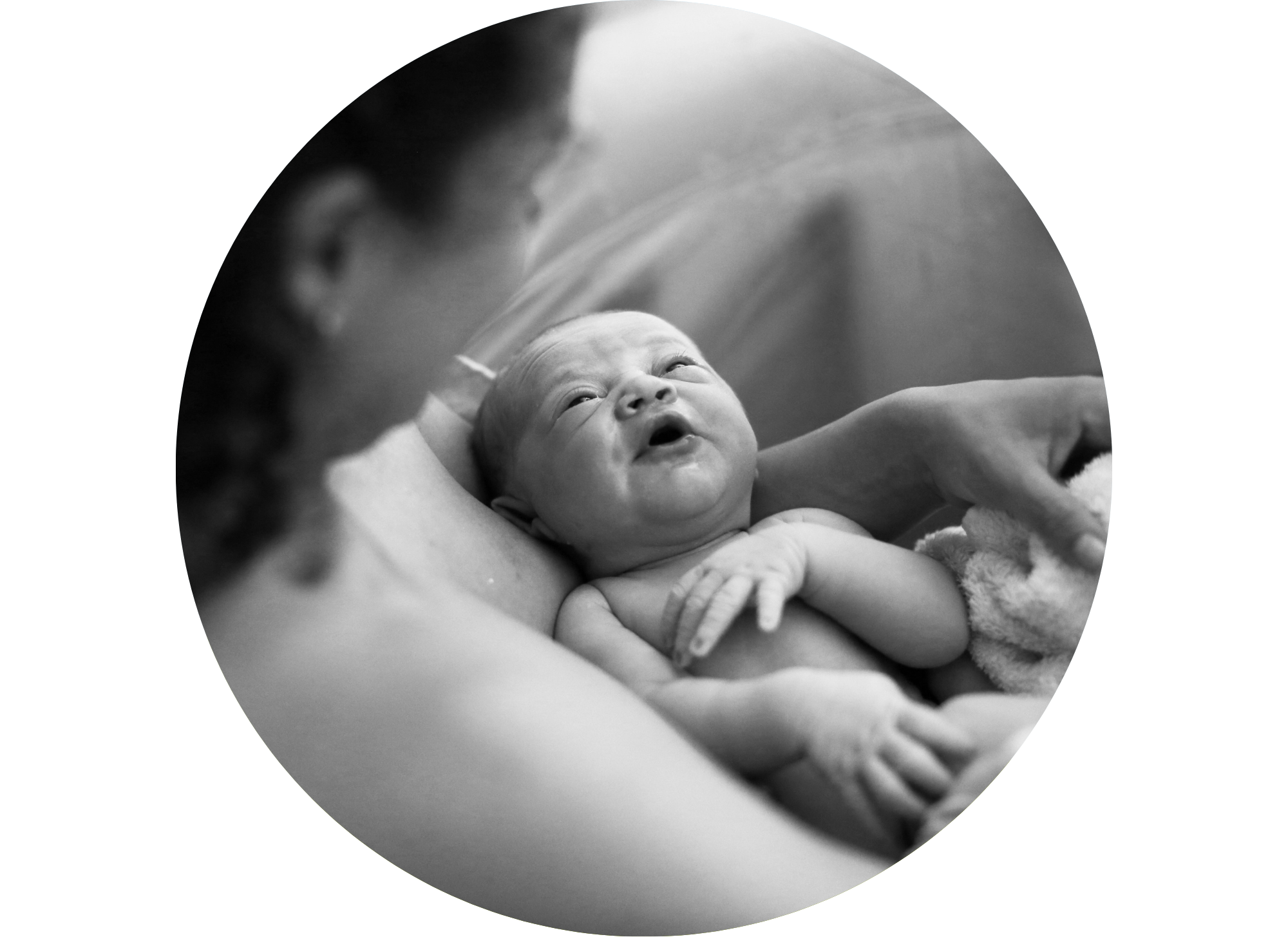 Mother in a birth tub holding and admiring her newborn in her arms.