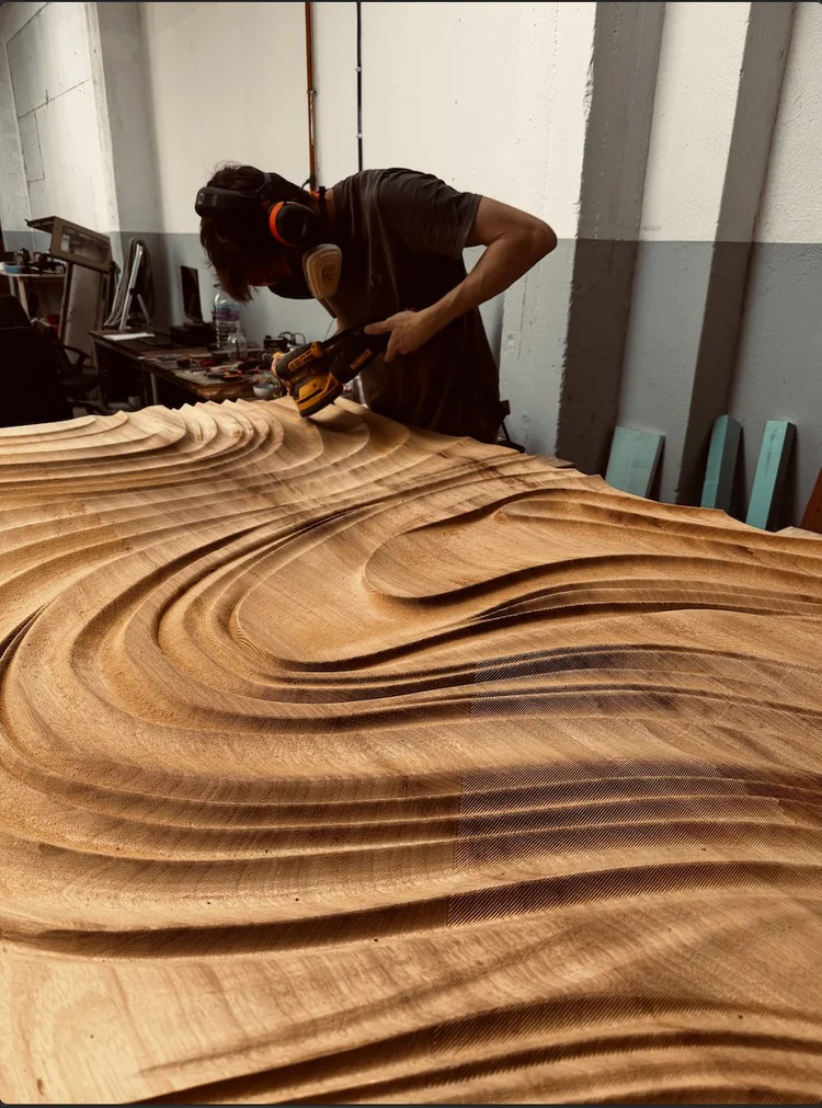 Hand sanding a carved door panel