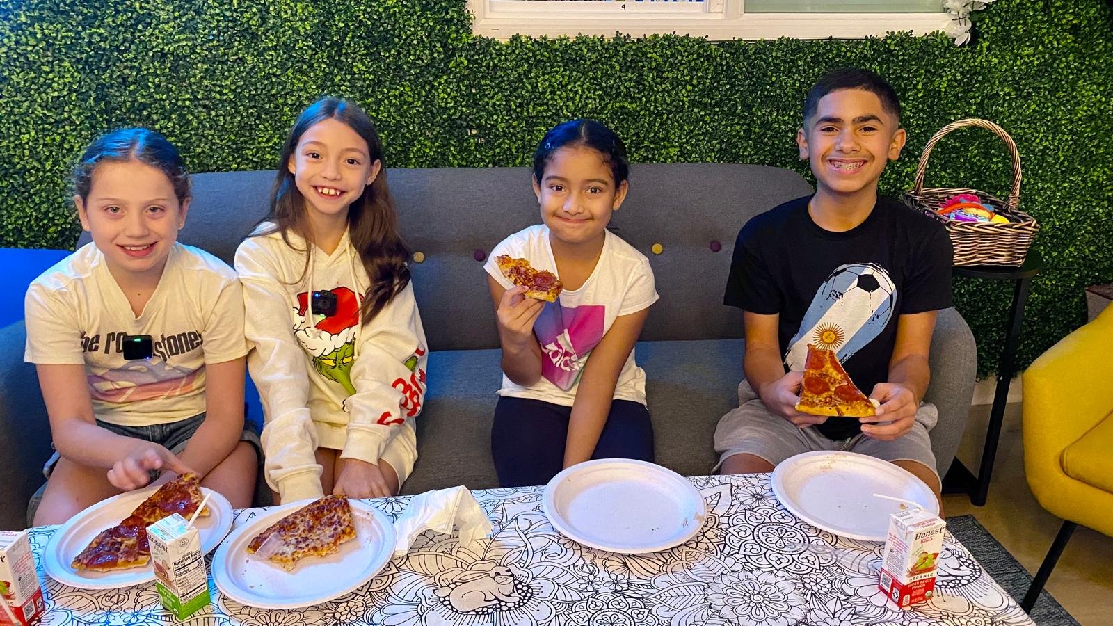 Kids eating pizza at Konekt Club during a Parents' Night Out Event