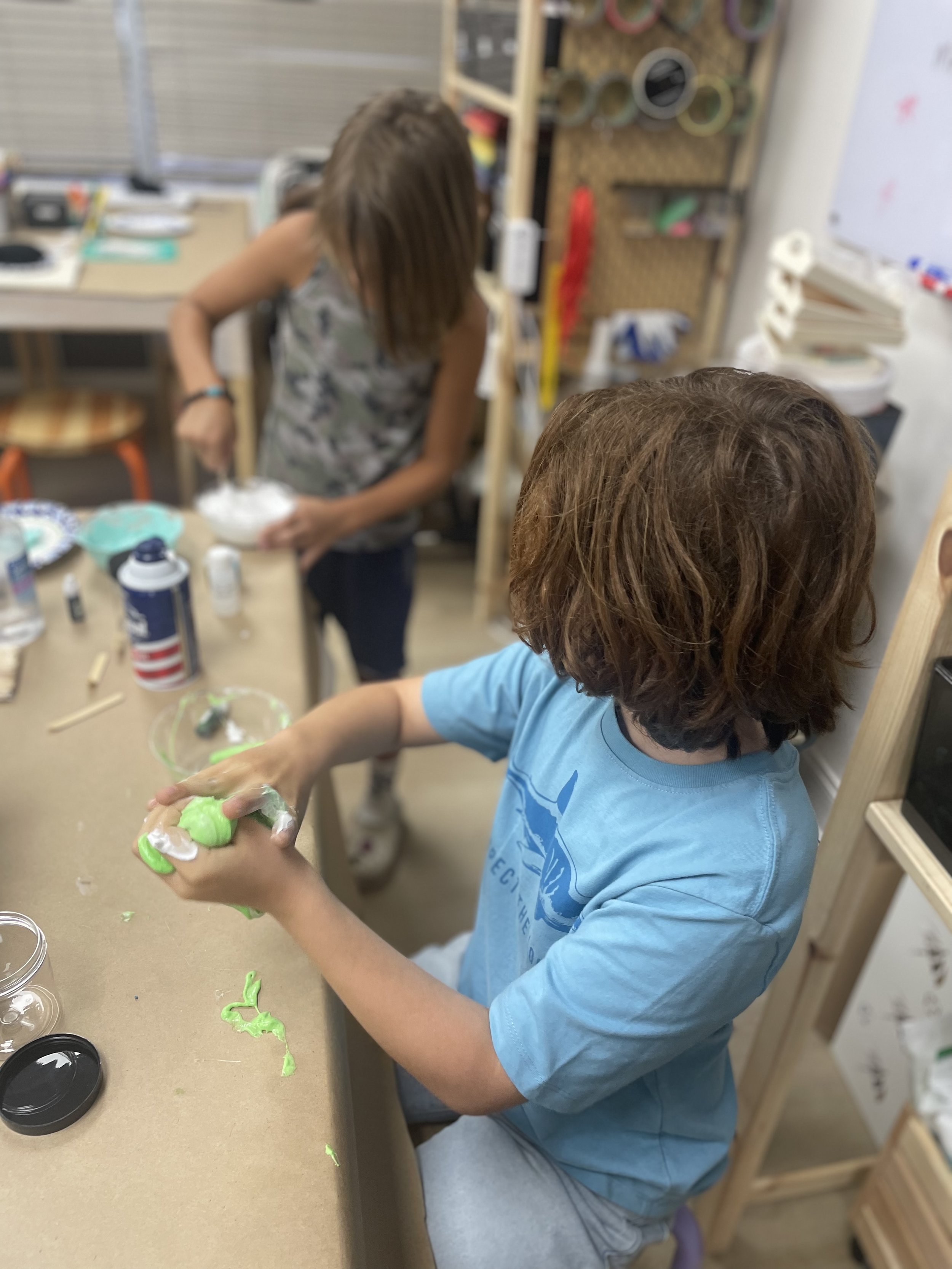 Young children making hands-on craft projects at Konekt Club makerspace