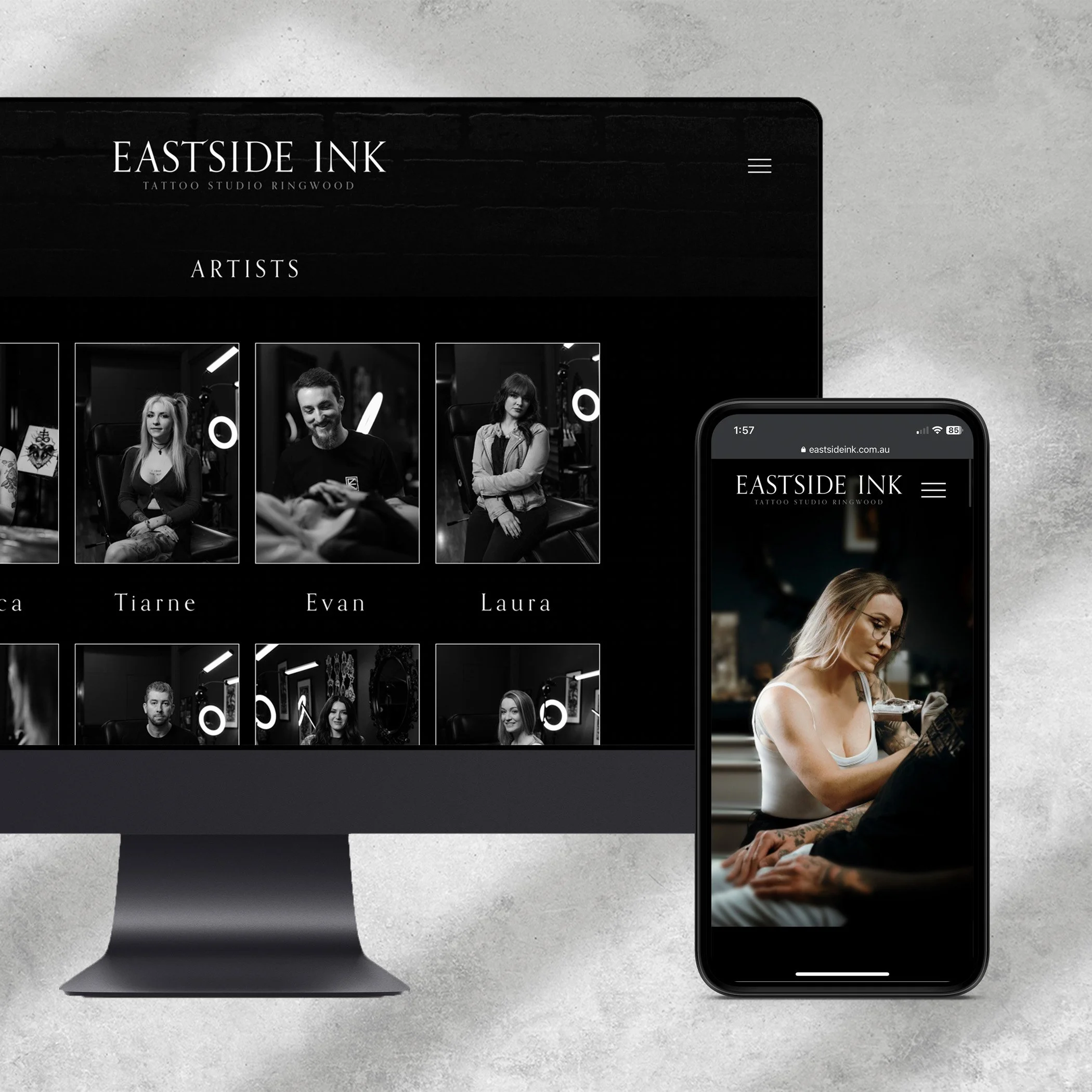 A smartphone displaying the website of Eastside Ink tattoo studio Ringwood, with photos of people and tattoos, placed on a gray surface next to a computer mouse.