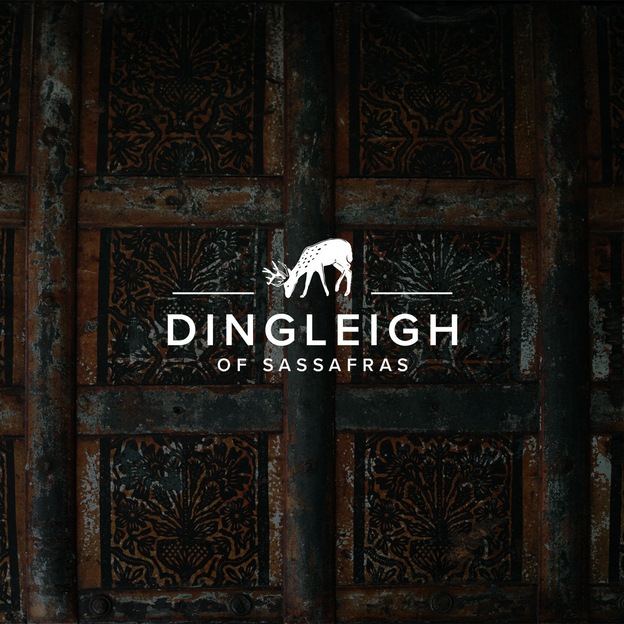 Logo for Dingleigh of Sassafras featuring a white outline of a deer with antlers, set against an intricate, weathered iron backdrop.