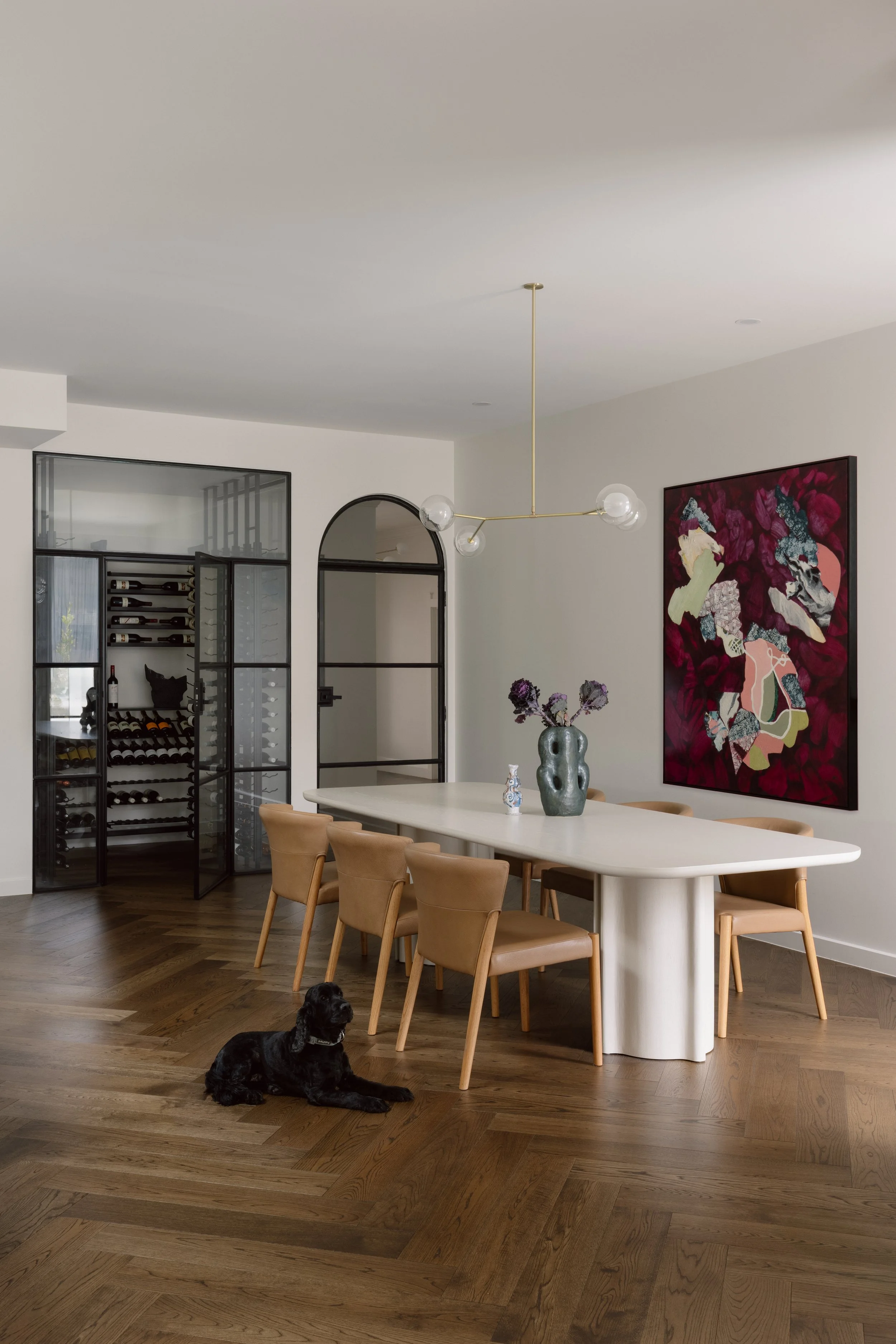 Dining area with architectural steel and glass wine room