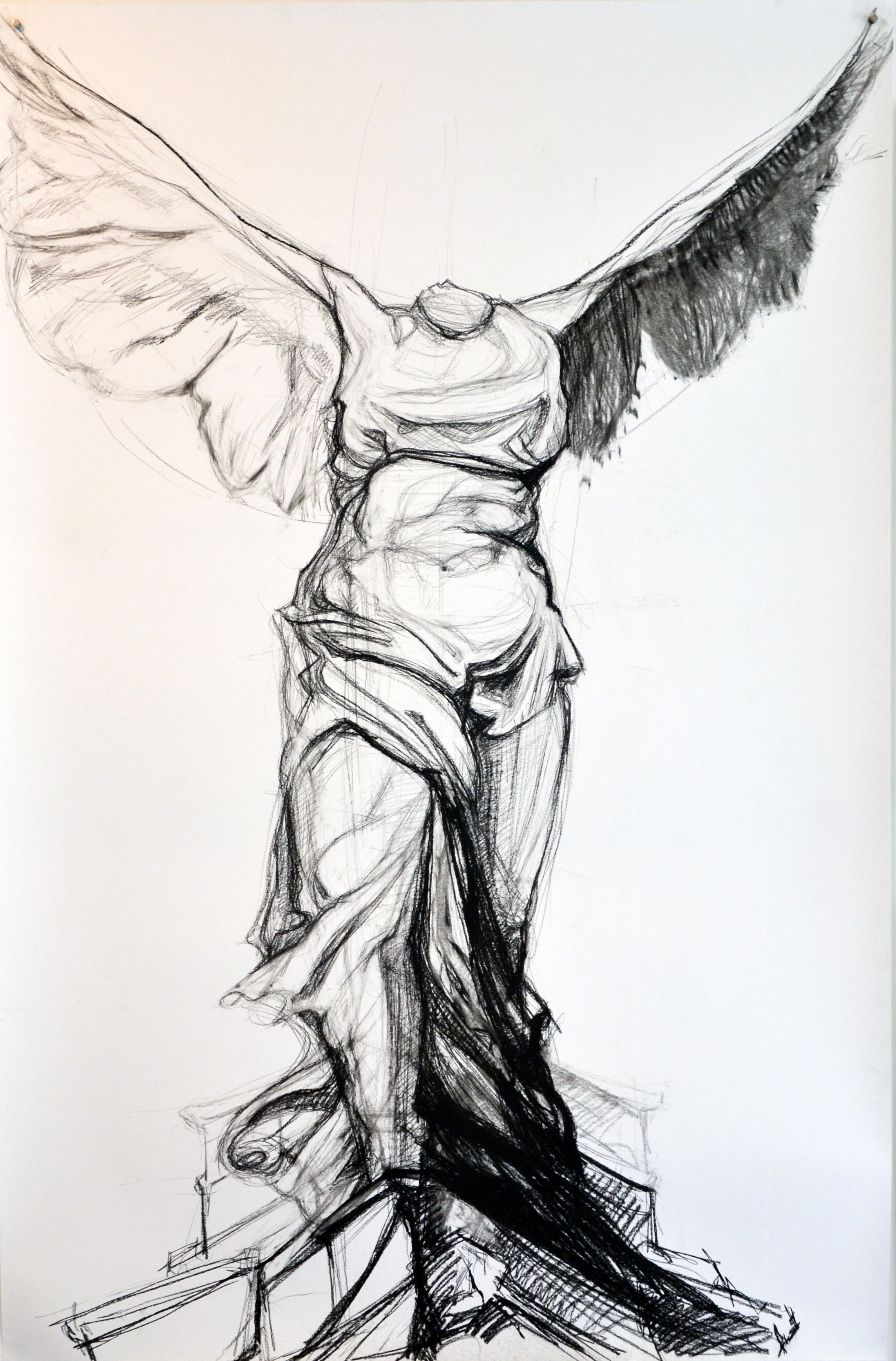 A black and white sketch of a crucifix, featuring a detailed depiction of Jesus Christ on the cross with outstretched arms.