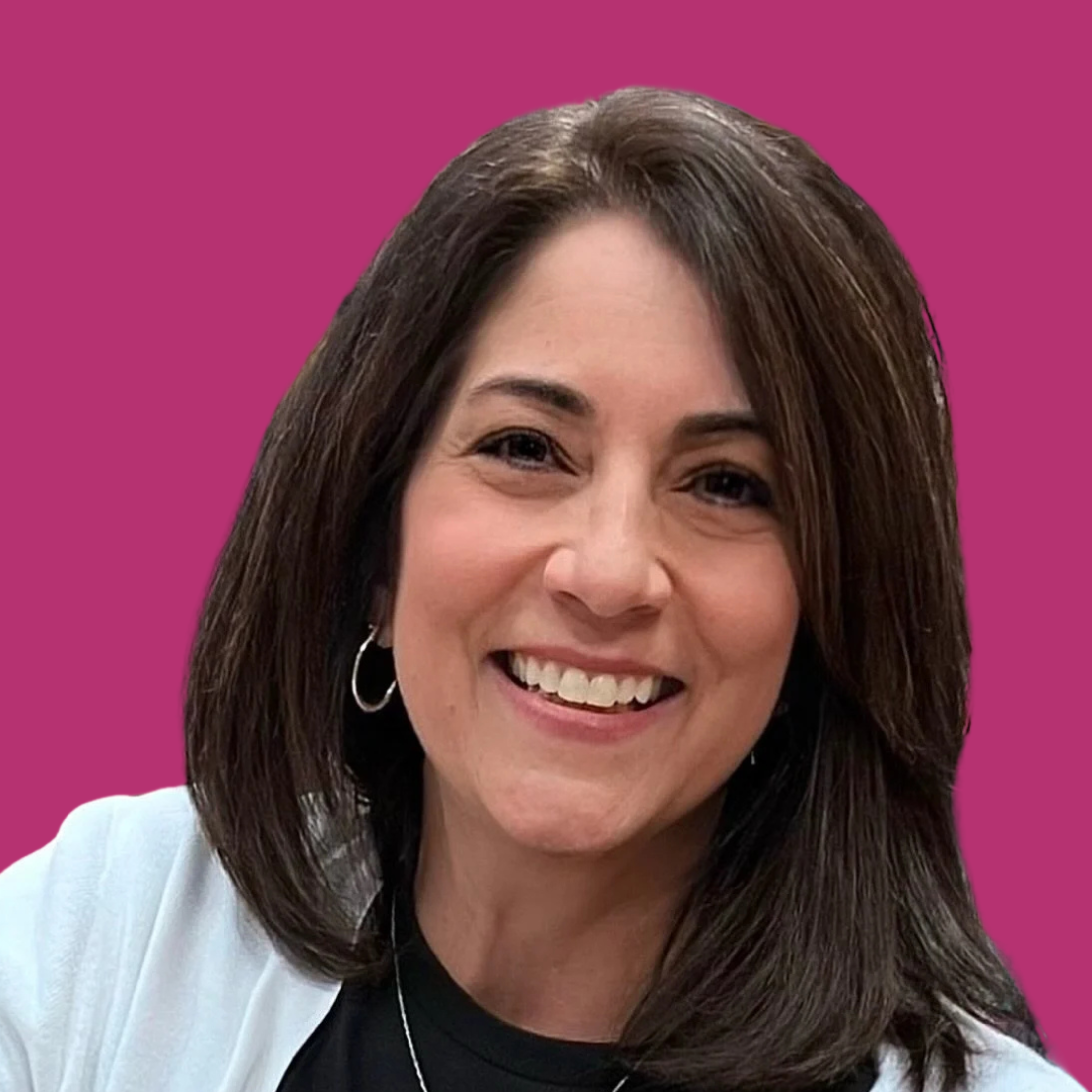 Close-up of a woman with shoulder-length brown hair smiling, wearing earrings and a light-colored blazer against a purple background.
