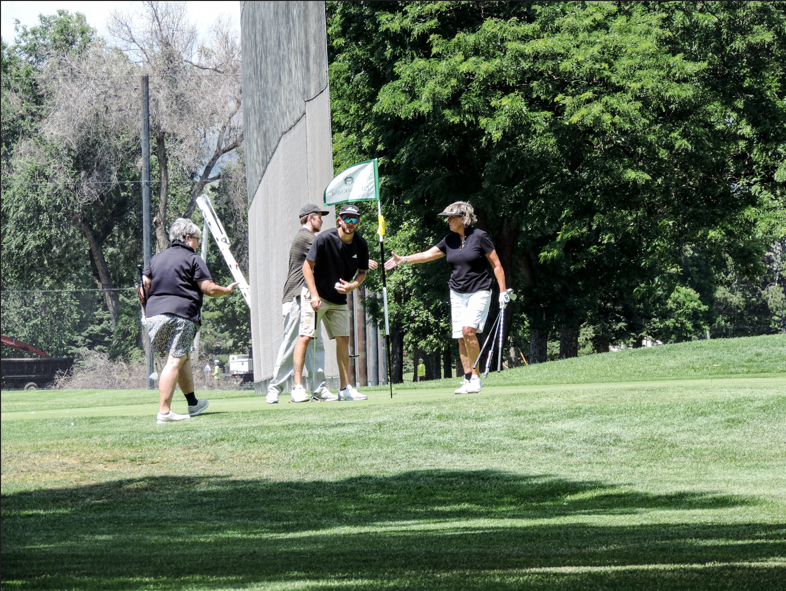 Handshakes are handed out as a display of sportsmanship after the scramble take place on the 9th green at City park golf coutse, on July 11th 2025, at 12:15pm