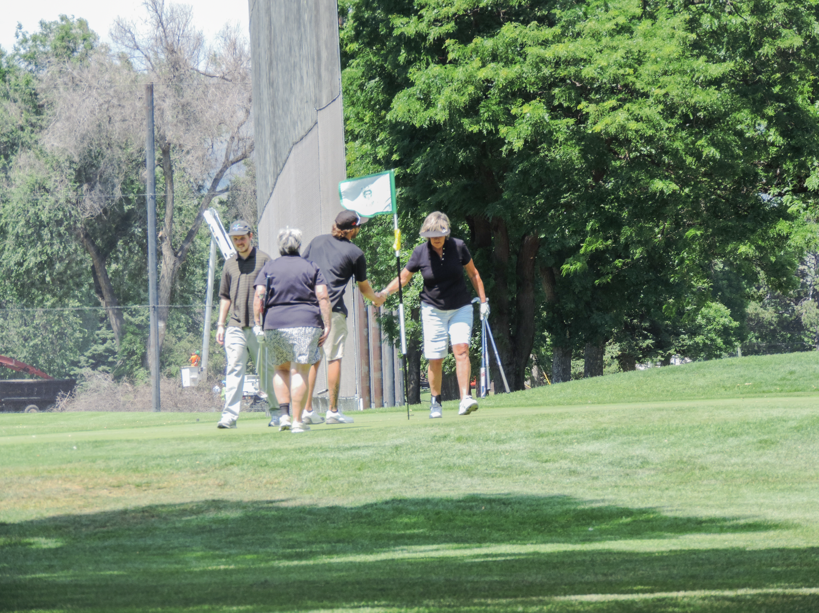 Handshakes are handed out as a display of sportsmanship after the scramble take place on the 9th green at City park golf coutse, on July 11th 2025, at 12:15pm