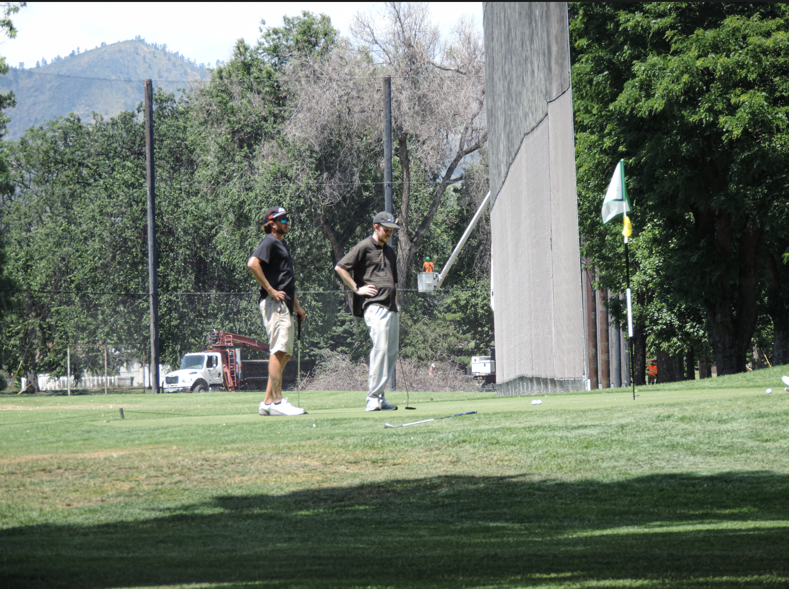 The team of boys addressing the missed putt on the 9th green at City Park Nine Golf Course, on July 11th 2025 at 12:15 pm for a photgraphy essay
