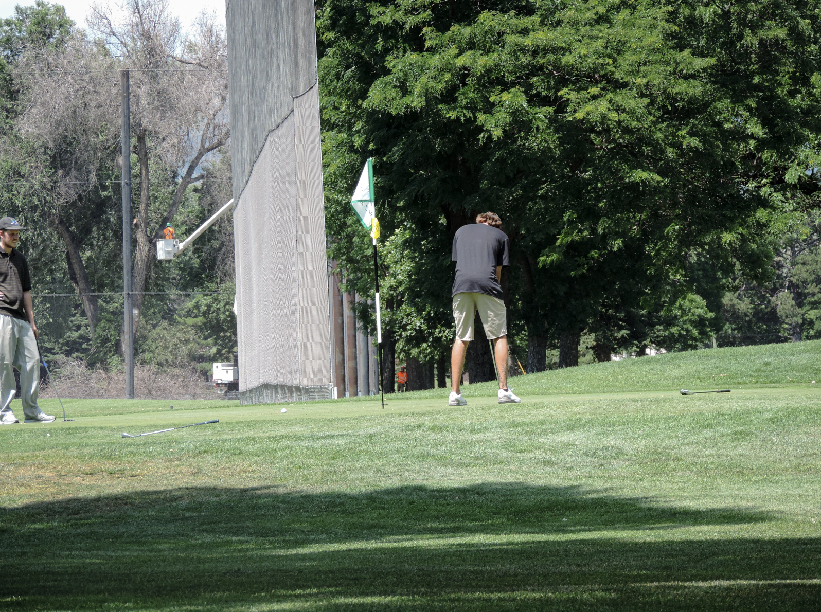 L:ining up a putt on the 9th green at City Park Nine Golf Course, on July 11th 2025 at 12:15 pm for a photgraphy essay