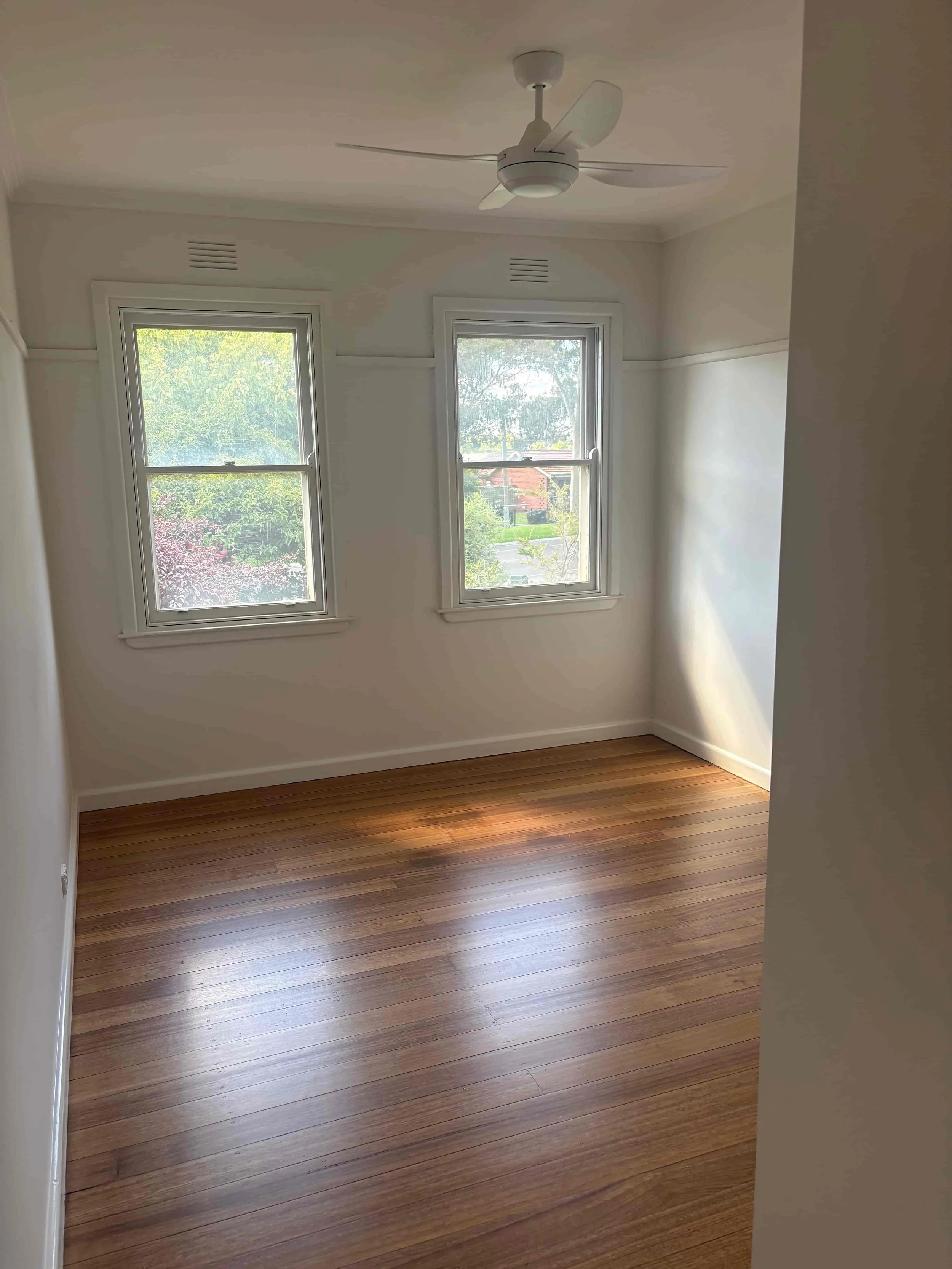 Secondary bedroom renovation at Hargreaves Street Bendigo with timber flooring, ceiling fan, and updated interior finishes