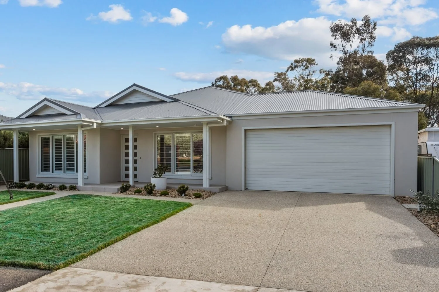 Finished single-storey home with rendered facade, portico entry, and double garage at Marnie Road, Bendigo, by AMW Builders.