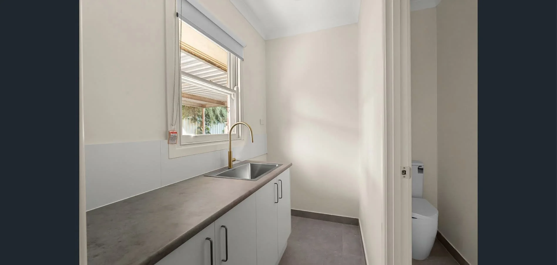 Laundry renovation at Hargreaves Street Bendigo with custom cabinetry, brass tapware, and updated finishes by AMW Builders.