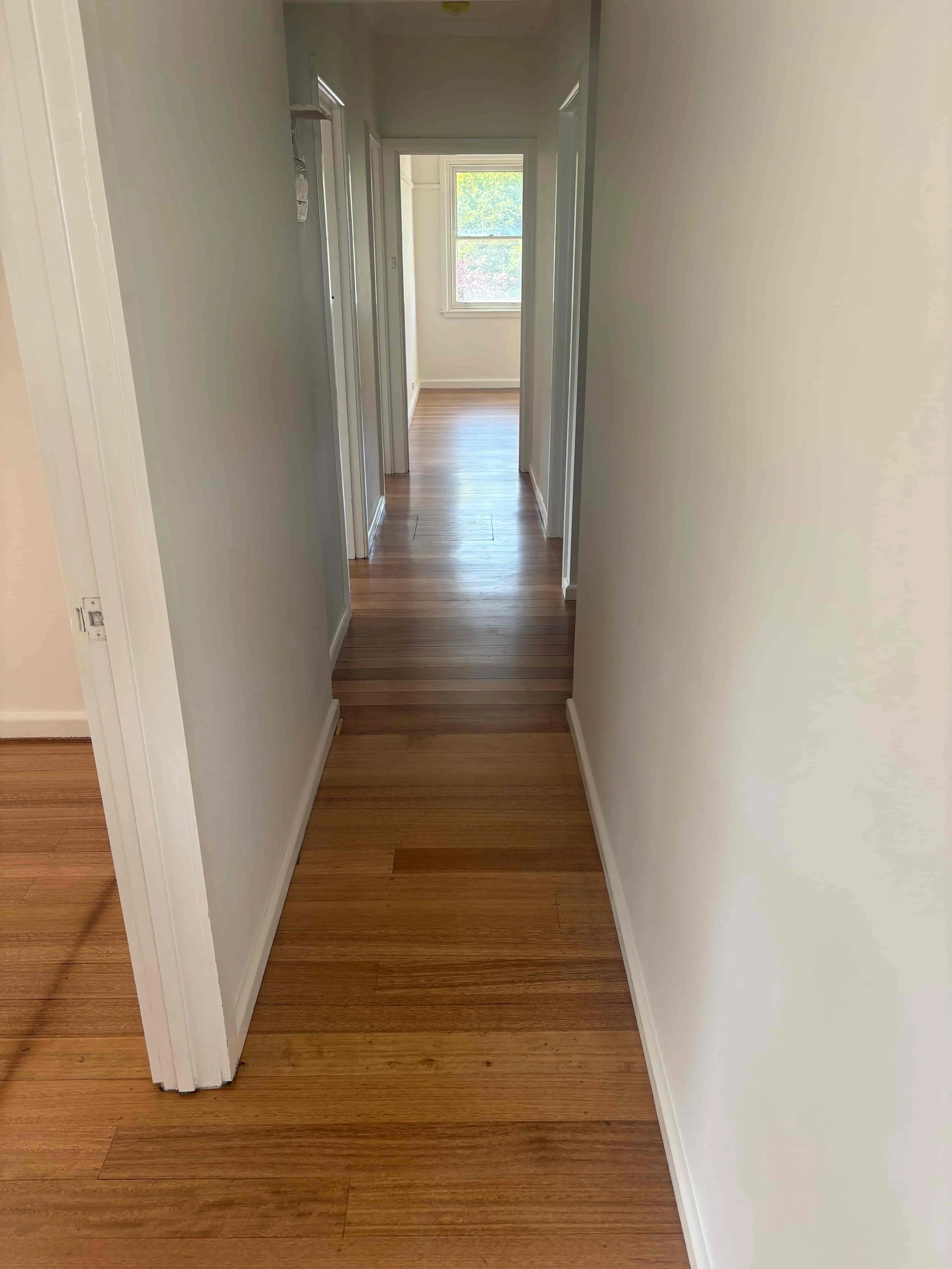 Hallway renovation at Hargreaves Street Bendigo showing restored timber flooring and refreshed interior layout by AMW Builders