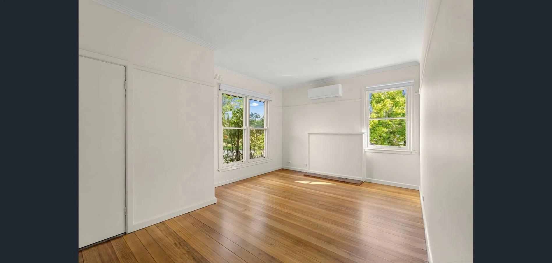 Living room renovation at Hargreaves Street in Bendigo with restored timber flooring, updated lighting, and refreshed interior by AMW Builders.