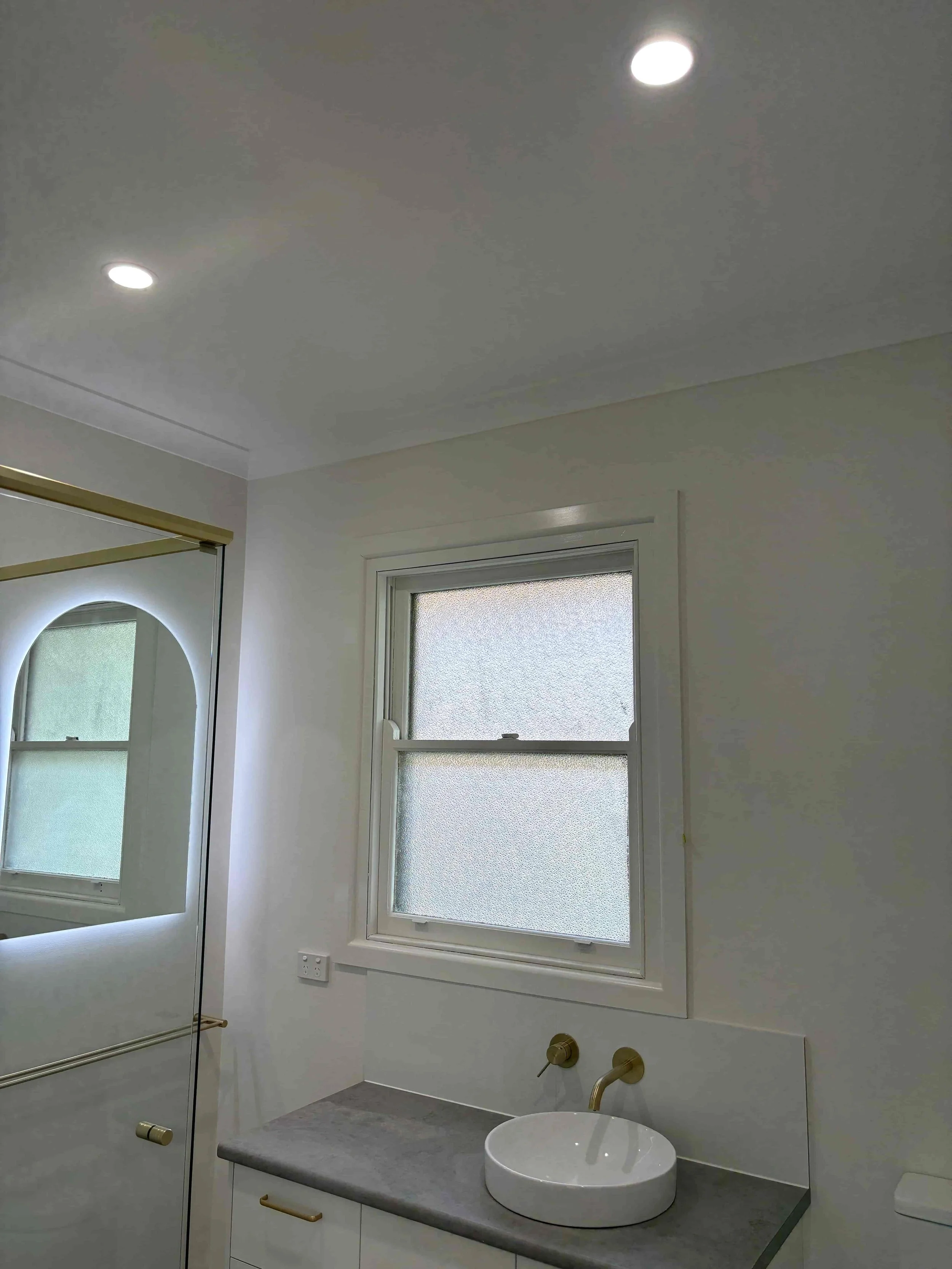 Bathroom renovation at Hargreaves Street Bendigo with modern vanity, wall-mounted tapware, and updated finishes by AMW Builders