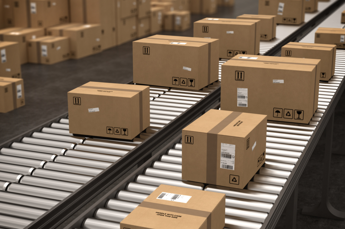 Numerous cardboard boxes on a conveyor belt in a warehouse