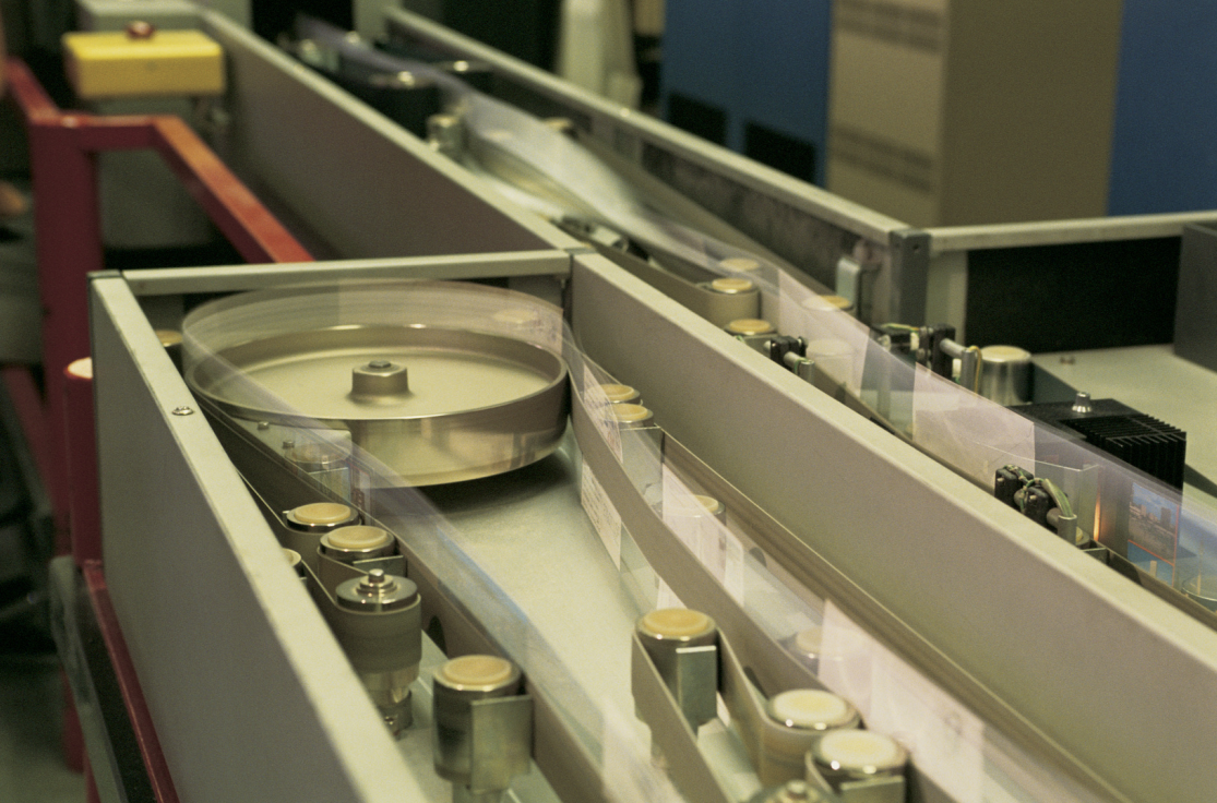 Close-up of a computer hard drive with spinning disks inside a metallic casing.