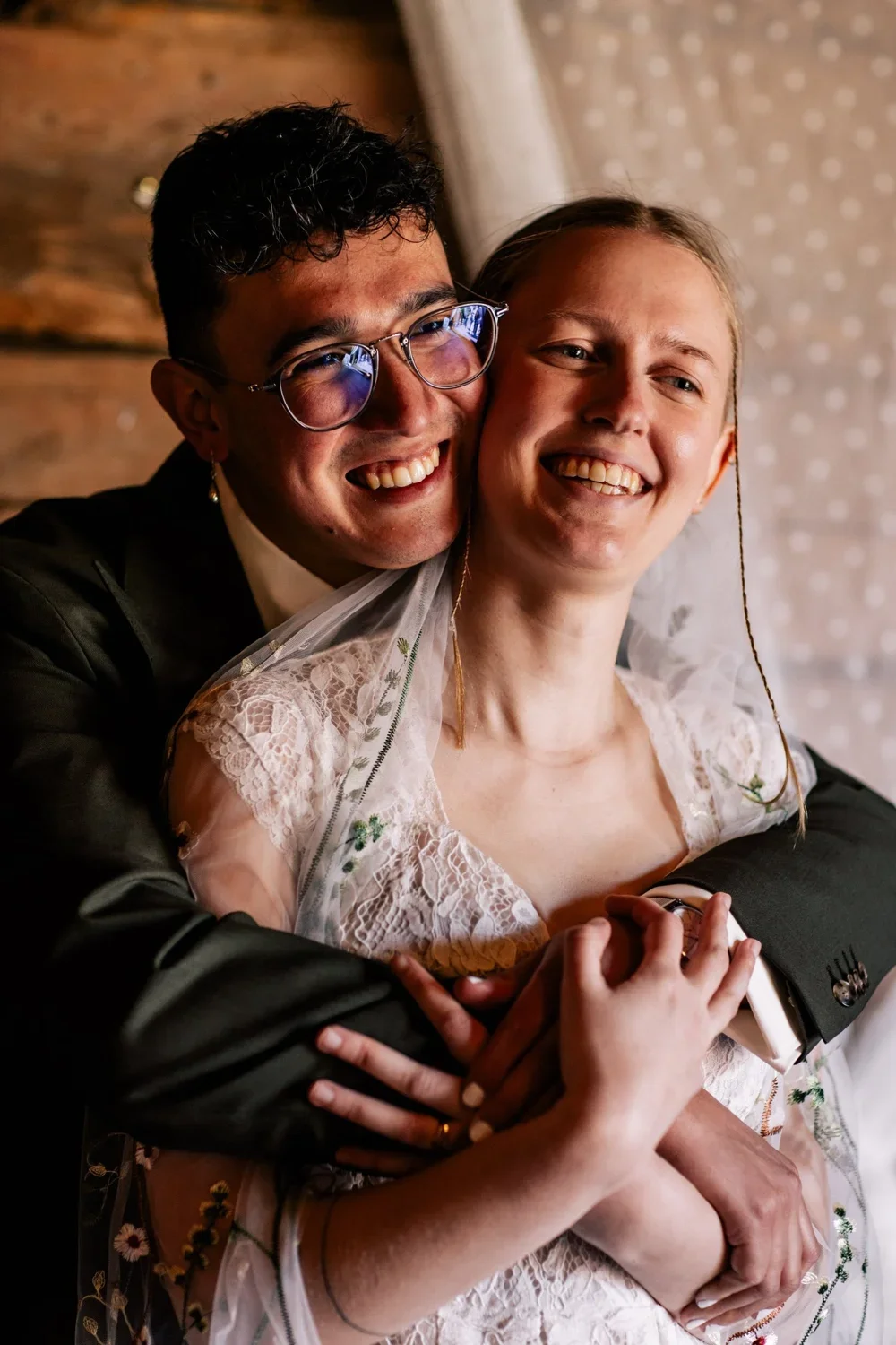 Disa och Andres tätt tillsammans i ett varmt porträtt inomhus.
