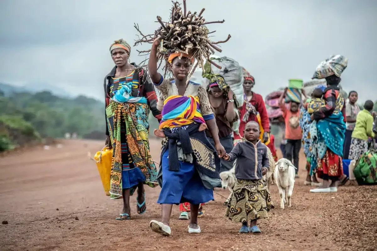 Some Congolese people travelling on a dirt road