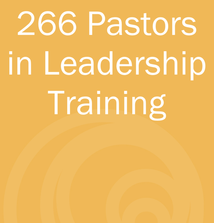 Statistics text that reads, '266 Pastors in Leadership Training.' on a yellow background with a circular pattern
