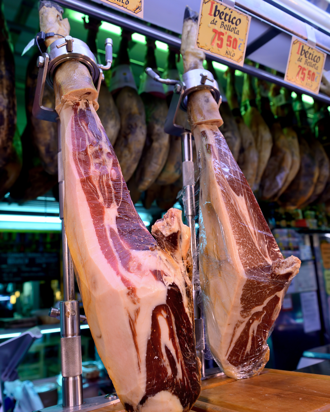 Jamon Iberico de Bellota hanging in a shop window in Spain