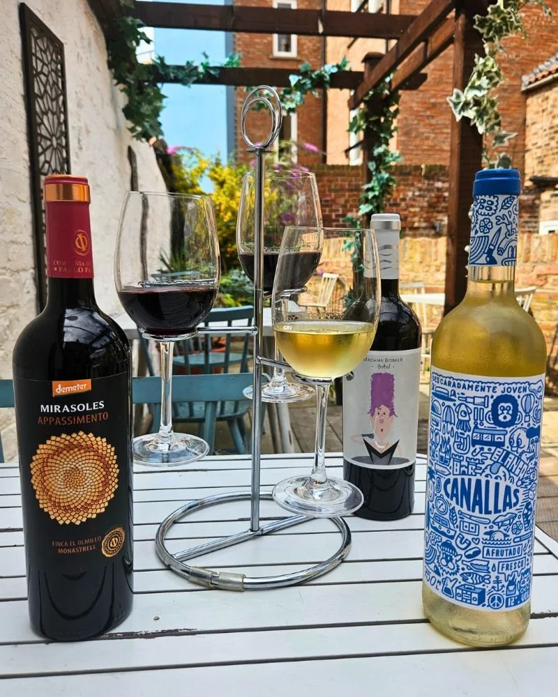 Image of three Valencia wine bottles and a valencia wine flight at Tabanco by Ambiente
