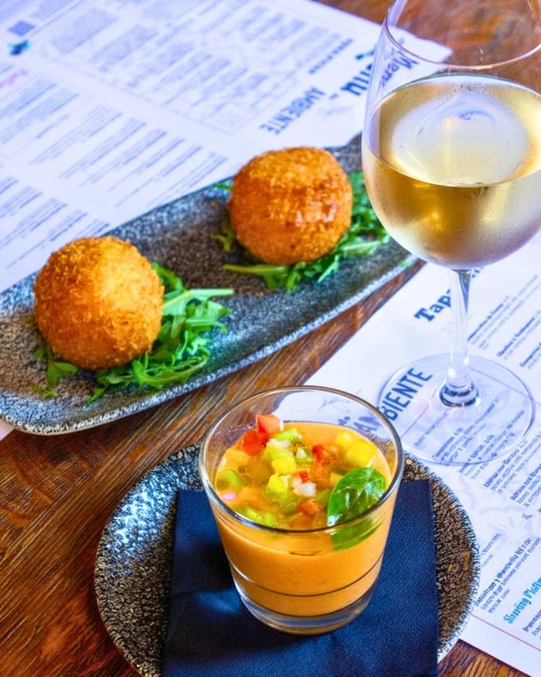 side image gazpacho, cheese & tomato croquettes and a glass of white wine