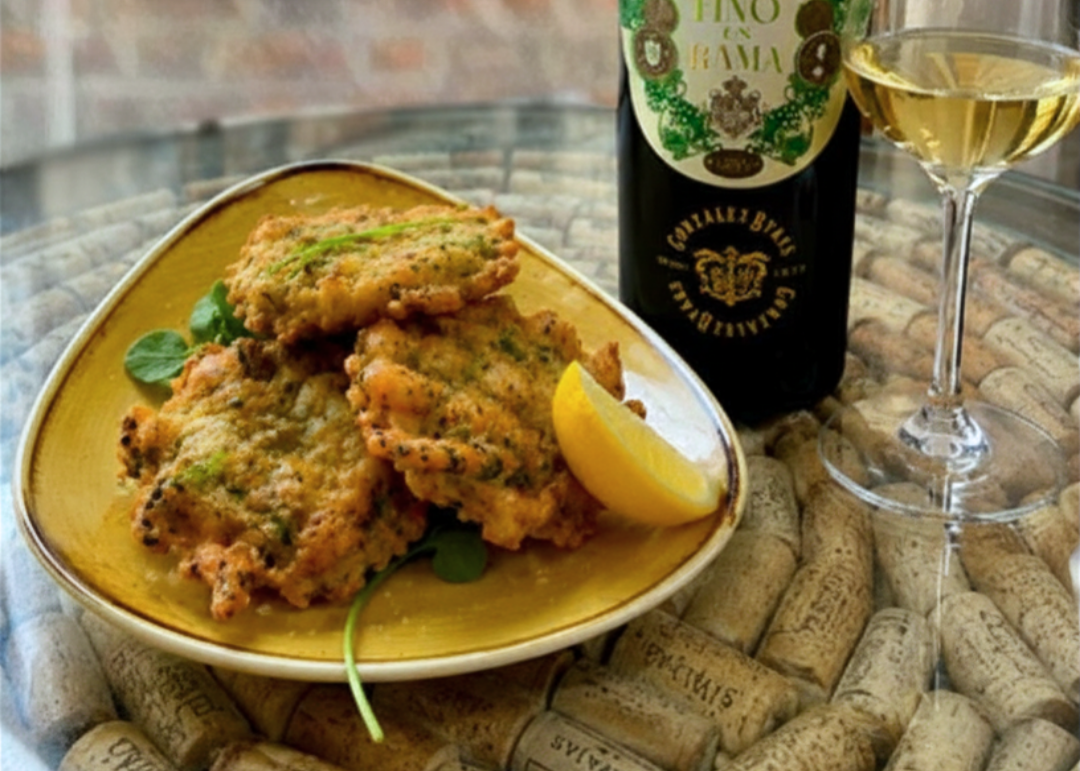 a plate of Tortillitas de Camarones with Tio Pepe En Rama