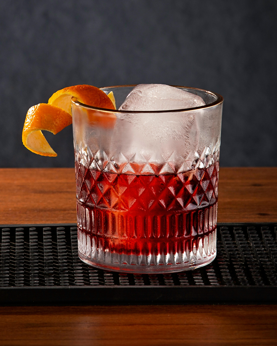 An image of a glass of Vermut (vermouth) with a slice of orange