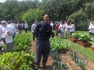 Chef Keith Jones stands in White House Garden with a group of chefs behind him.jpg