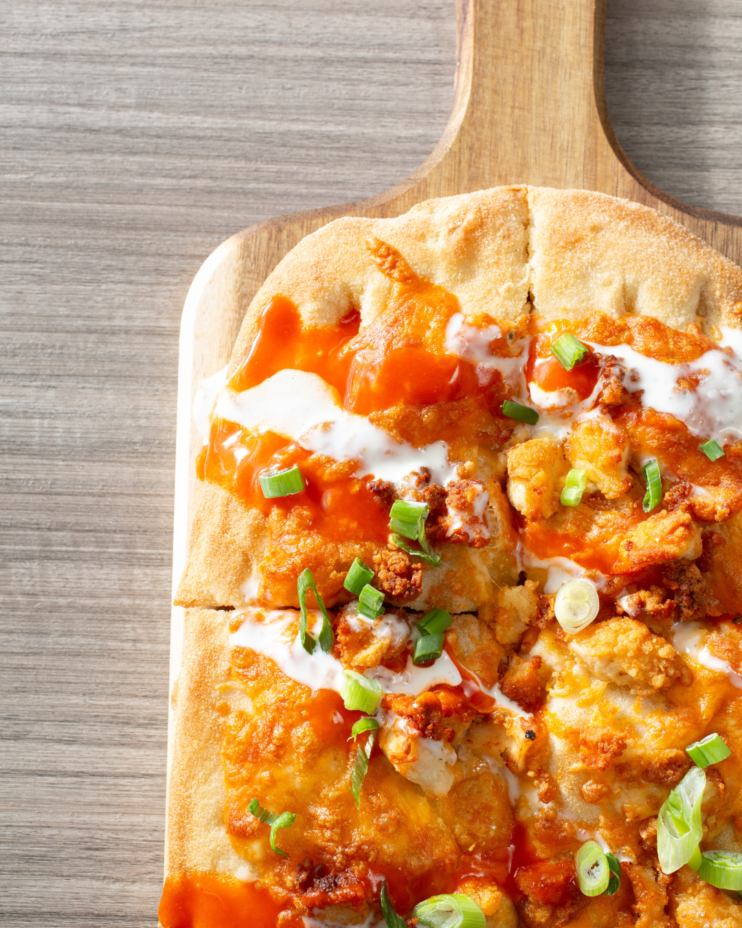 buffalo chicken flatbread on wood paddle