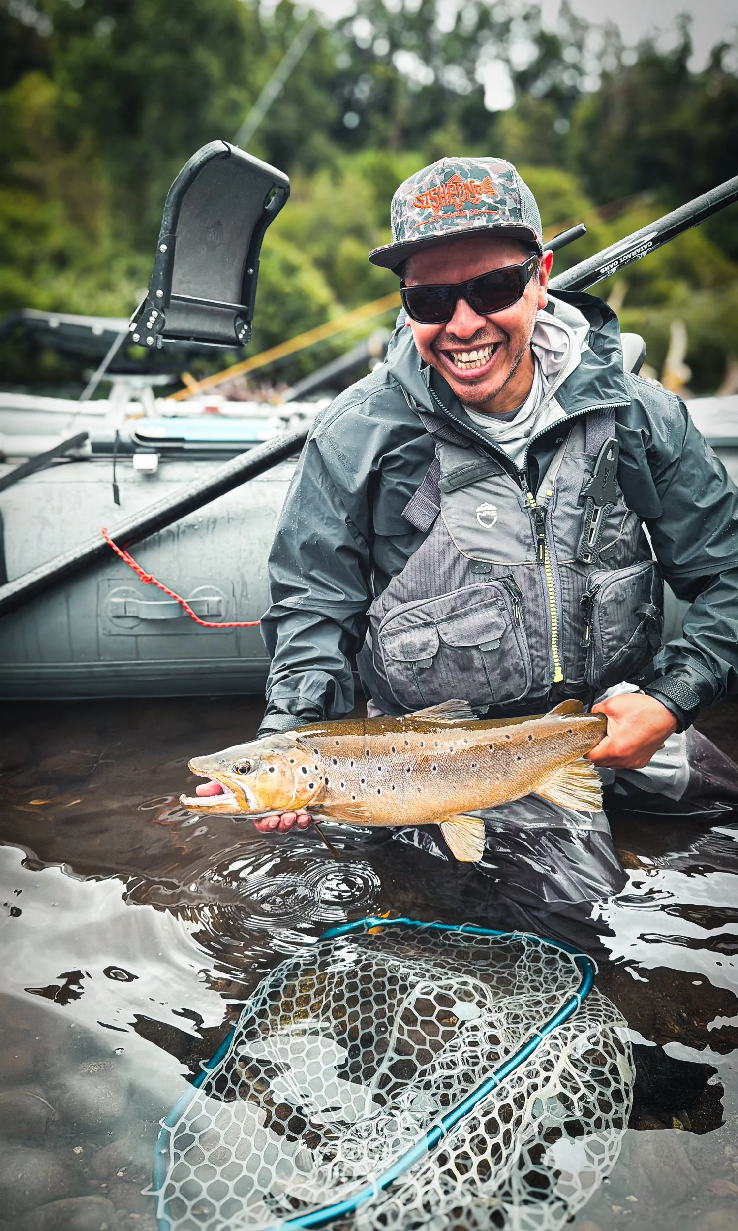 Fly fishing guide holding a trout in North Patagonia